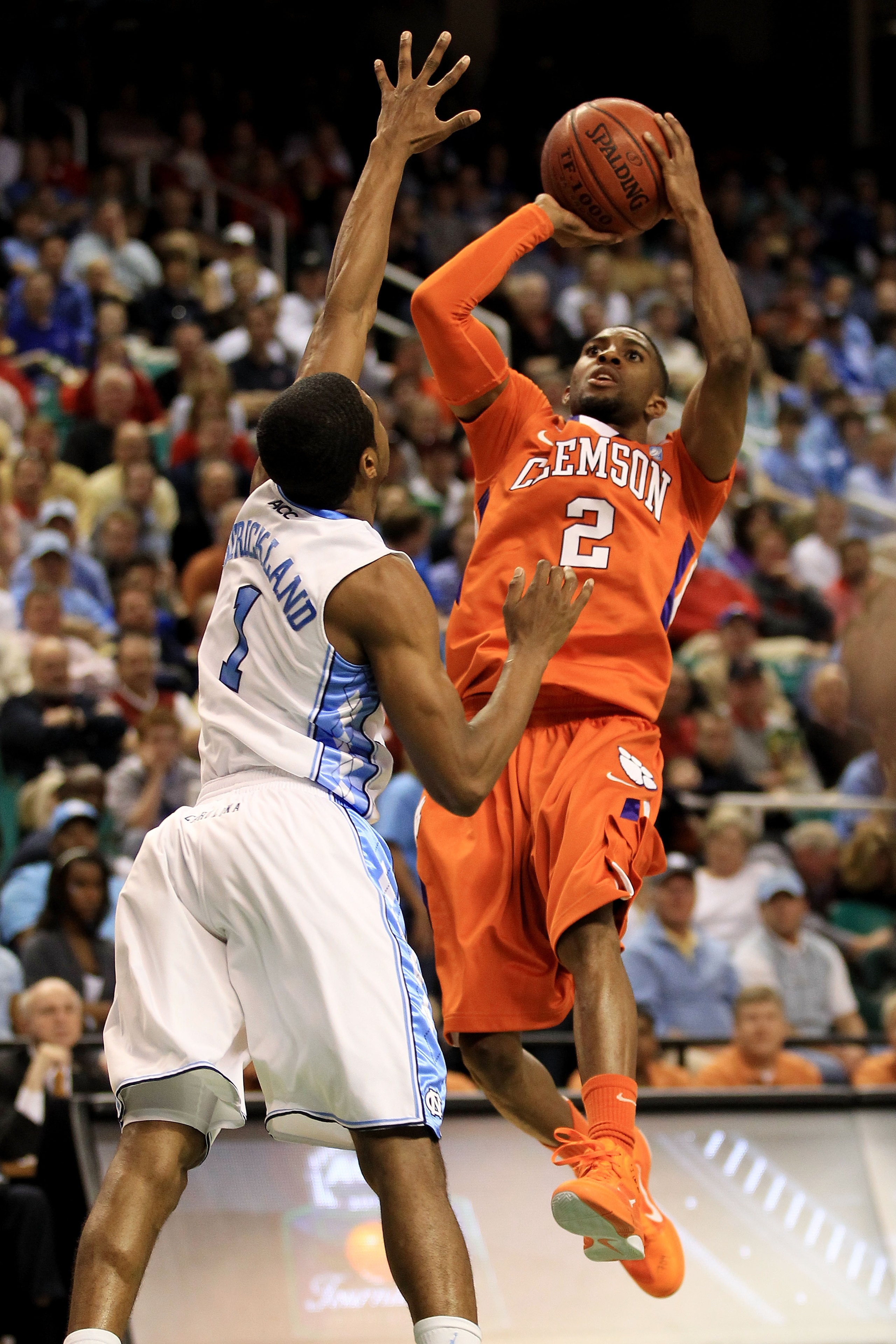 GREENSBORO, NC - MARCH 12:  Demontez Stitt #2 of the Clemson Tigers shoots against Dexter Strickland #1 of the North Carolina Tar Heels in the semifinals of the 2011 ACC men's basketball tournament at the Greensboro Coliseum on March 12, 2011 in Greensbor