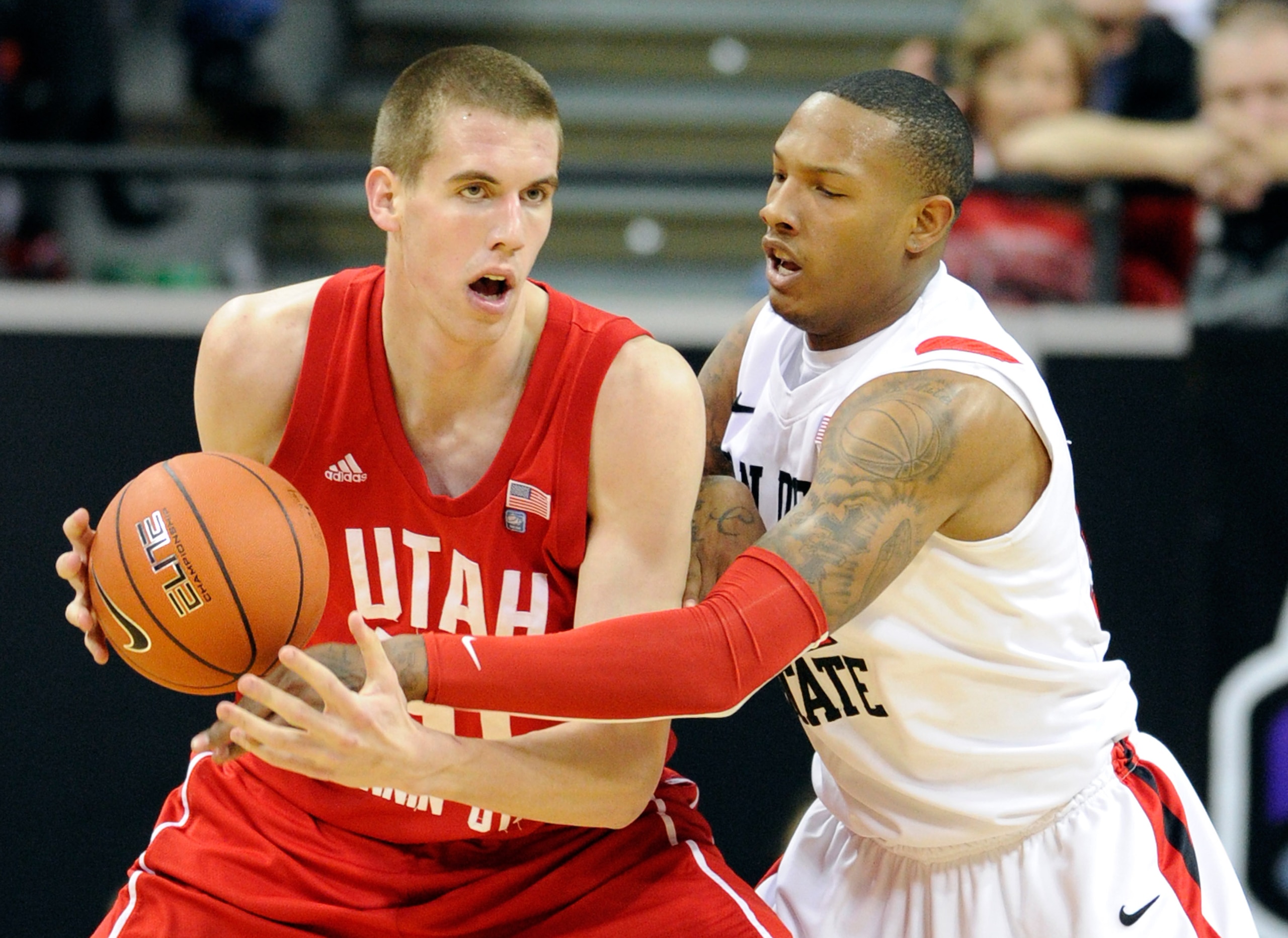 LAS VEGAS, NV - MARCH 10:  Billy White #32 of the San Diego State Aztecs guards David Foster #51 of the Utah Utes during a quarterfinal game of the Conoco Mountain West Conference Basketball tournament at the Thomas & Mack Center March 10, 2011 in Las Veg