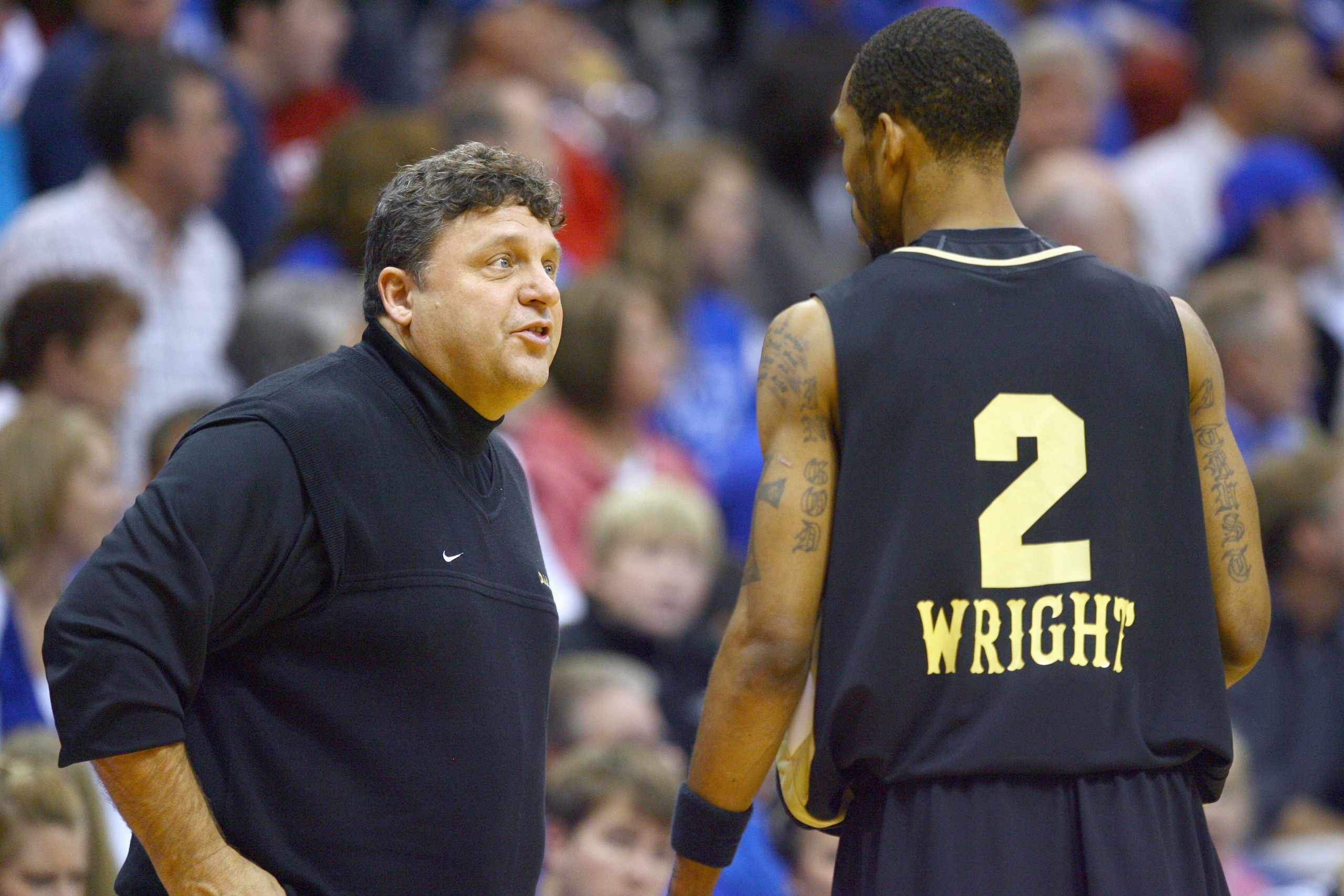 LAWRENCE, KS - NOVEMBER 25:  Head coach Greg Kampe of the Oakland Golden Grizzlies coaches Larry Wright #2 during the game against the Kansas Jayhawks on November 25, 2009 at Allen Fieldhouse in Lawrence, Kansas. (Photo by Jamie Squire/Getty Images)