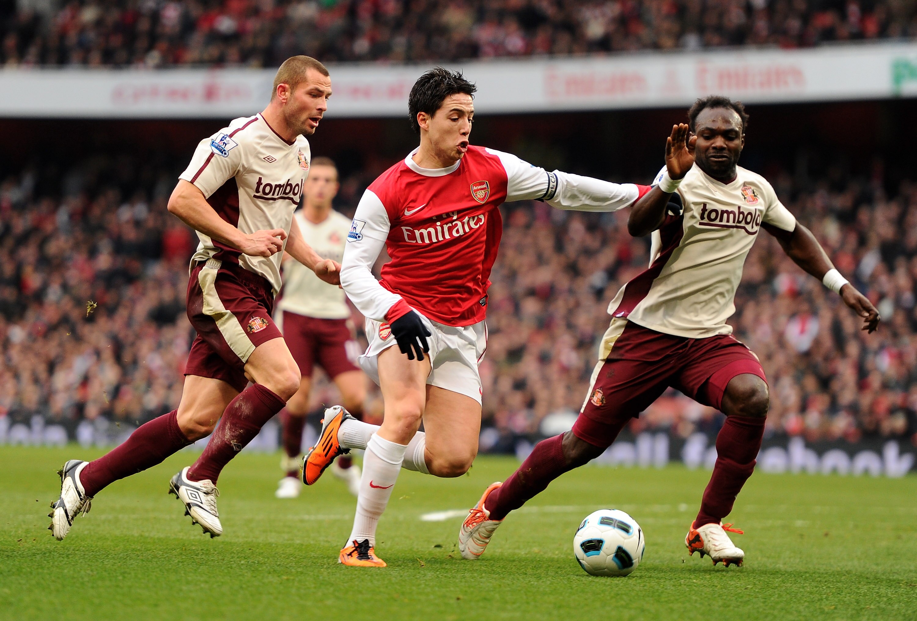 LONDON, ENGLAND - MARCH 05:  Samir Nasri of Arsenal holds off pressure from Phillip Bardsley and John Mensah of Sunderland during the Barclays Premier League match between Arsenal and Sunderland at Emirates Stadium on March 5, 2011 in London, England.  (P