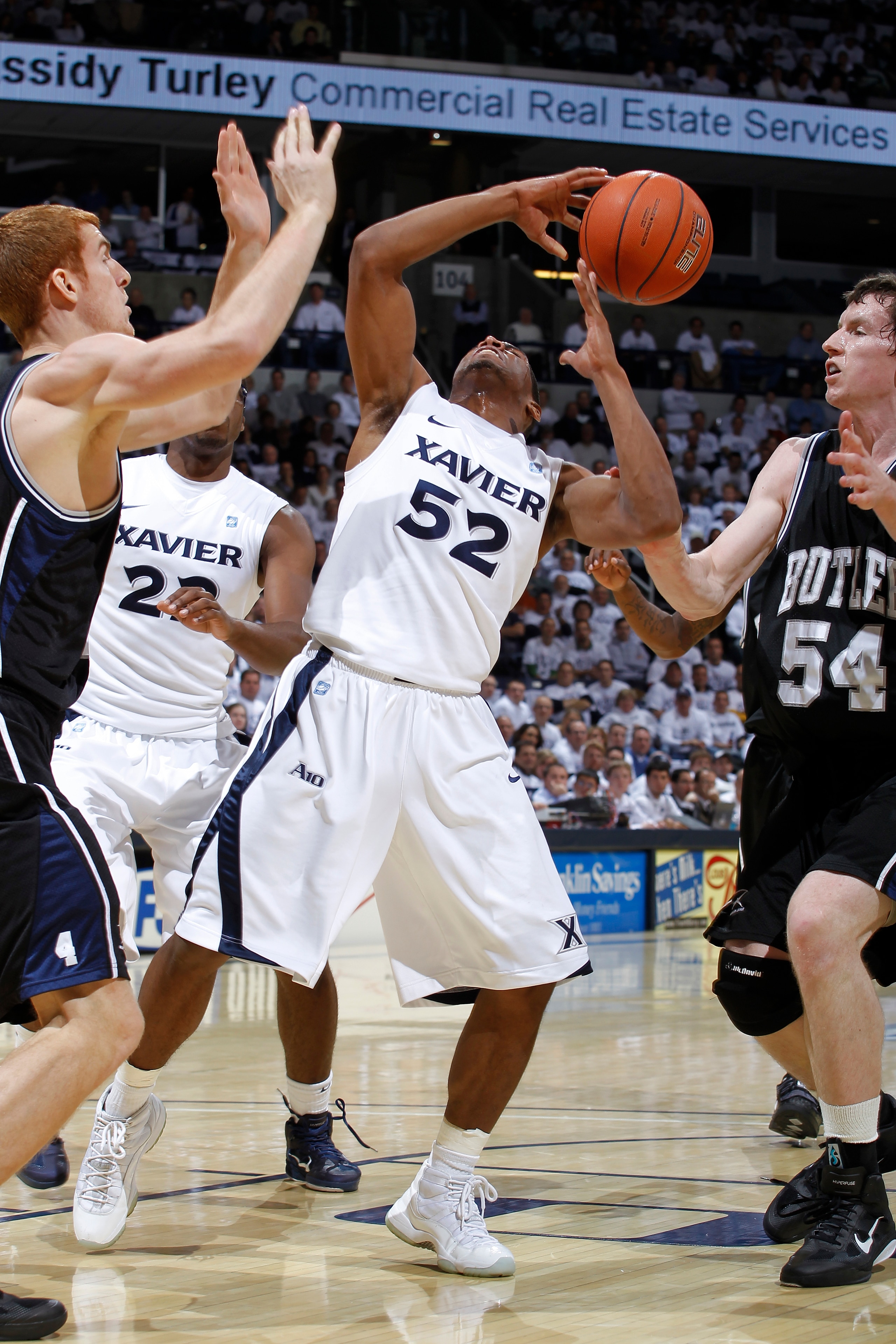CINCINNATI, OH - DECEMBER 9: Tu Holloway #52 of the Xavier Musketeers has the ball knocked away by Matt Howard #54 of the Butler Bulldogs at Cintas Center on December 9, 2010 in Cincinnati, Ohio. Xavier defeated Butler 51-49. (Photo by Joe Robbins/Getty I
