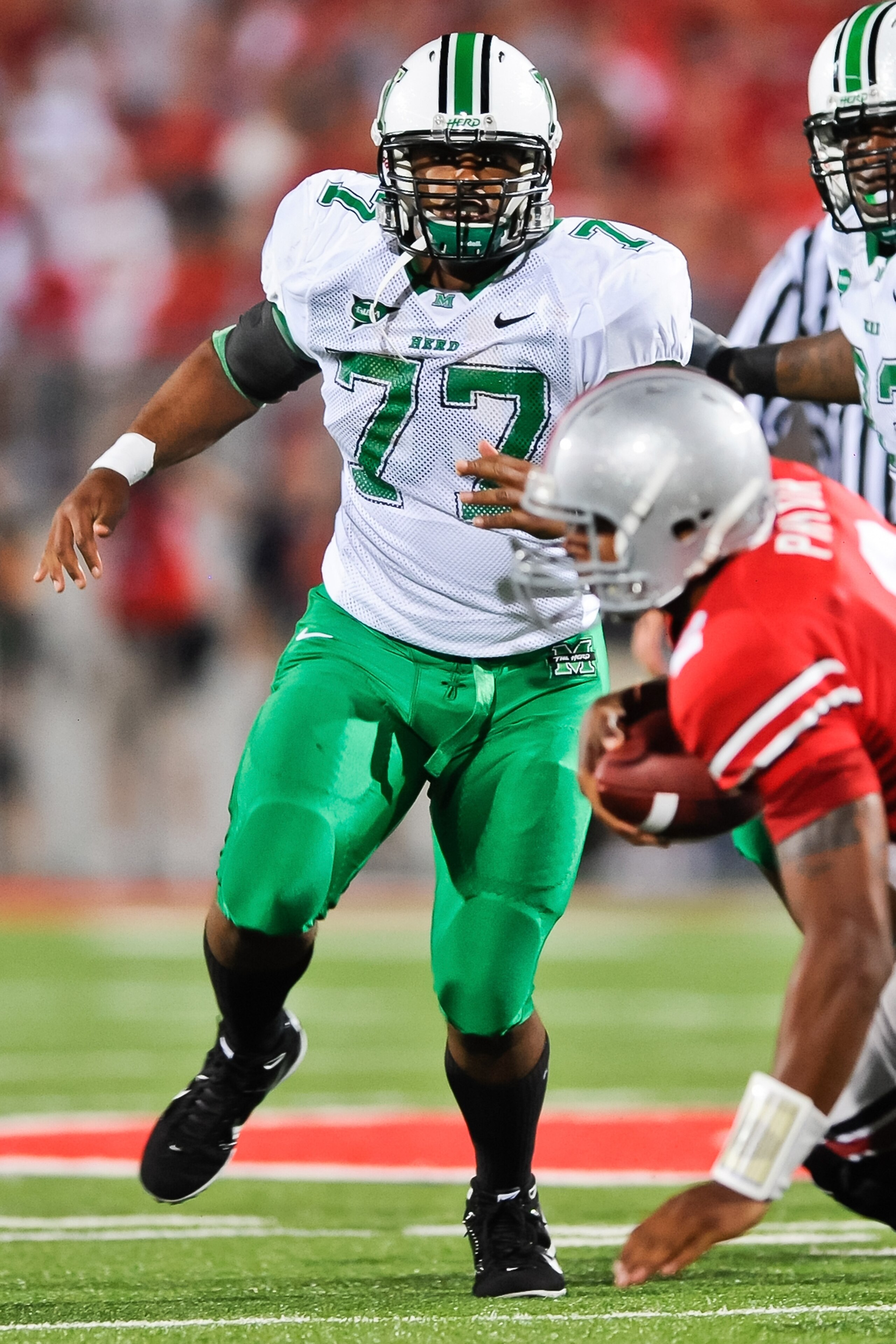 COLUMBUS, OH - SEPTEMBER 2: DeMetrius Thompson #77 of the Marshall Thundering Herd pursues the ballcarrier against the Ohio State Buckeyes at Ohio Stadium on September 2, 2010 in Columbus, Ohio. (Photo by Jamie Sabau/Getty Images)