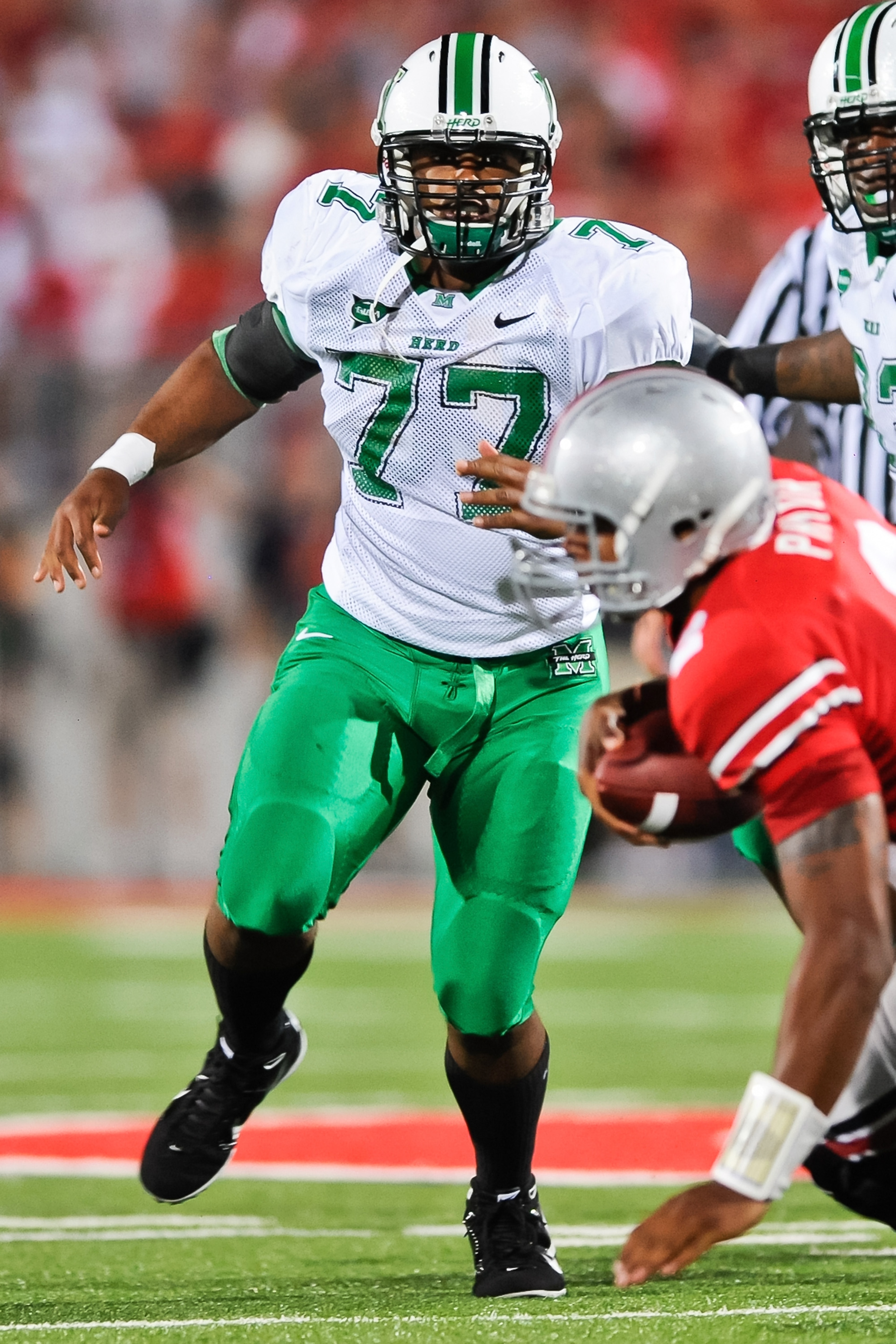 COLUMBUS, OH - SEPTEMBER 2: DeMetrius Thompson #77 of the Marshall Thundering Herd pursues the ballcarrier against the Ohio State Buckeyes at Ohio Stadium on September 2, 2010 in Columbus, Ohio. (Photo by Jamie Sabau/Getty Images) COLUMBUS, OH - SEPTEMBER 2: DeMetrius Thompson #77 of the Marshall Thundering Herd pursues the ballcarrier against the Ohio State Buckeyes at Ohio Stadium on September 2, 2010 in Columbus, Ohio. (Photo by Jamie Sabau/Getty Images)