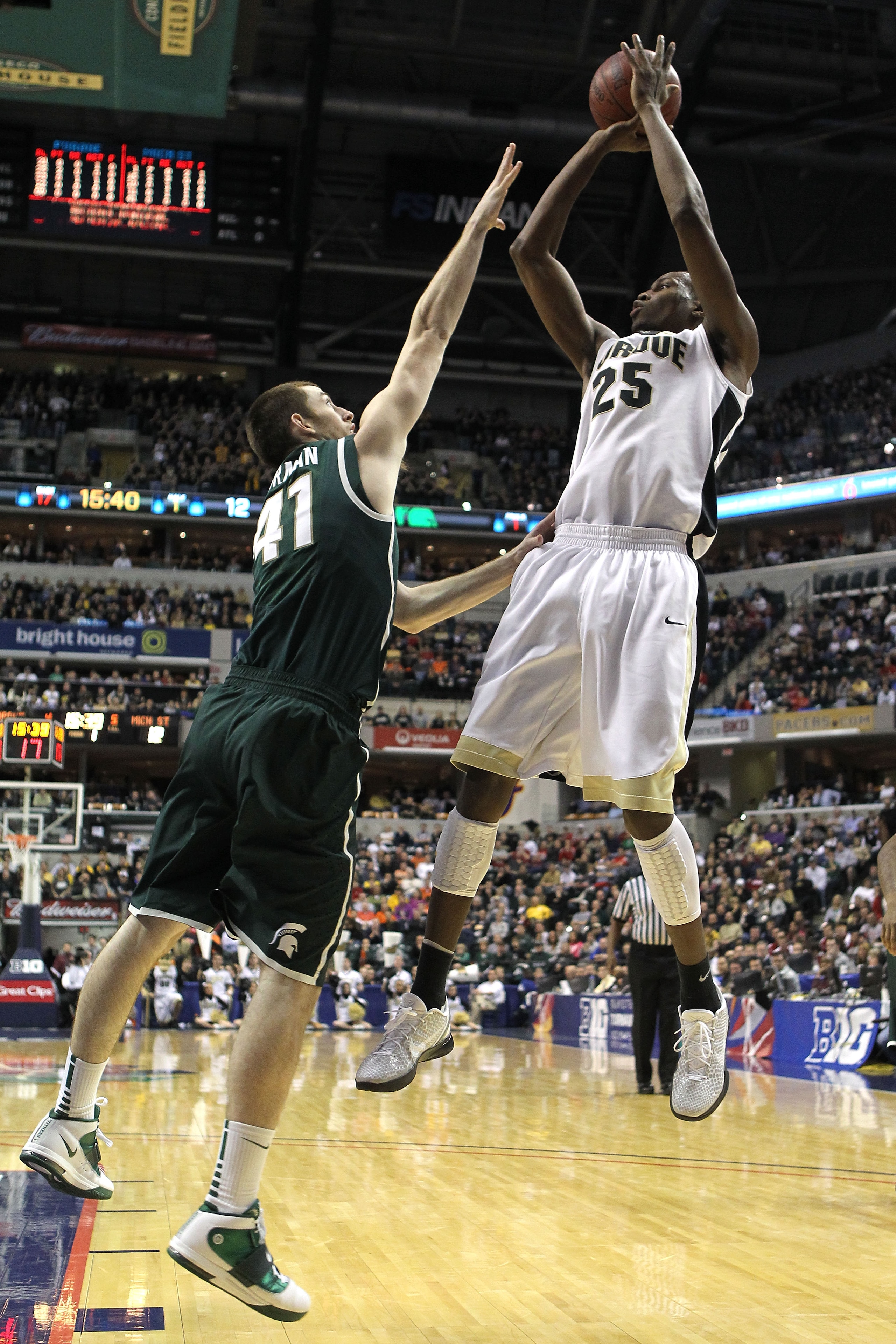 INDIANAPOLIS, IN - MARCH 11:  JaJuan Johnson #25 of the Purdue Boilermakers attempts a shot against Garrick Sherman #41 of the Michigan State Spartans during the quarterfinals of the 2011 Big Ten Men's Basketball Tournament at Conseco Fieldhouse on March