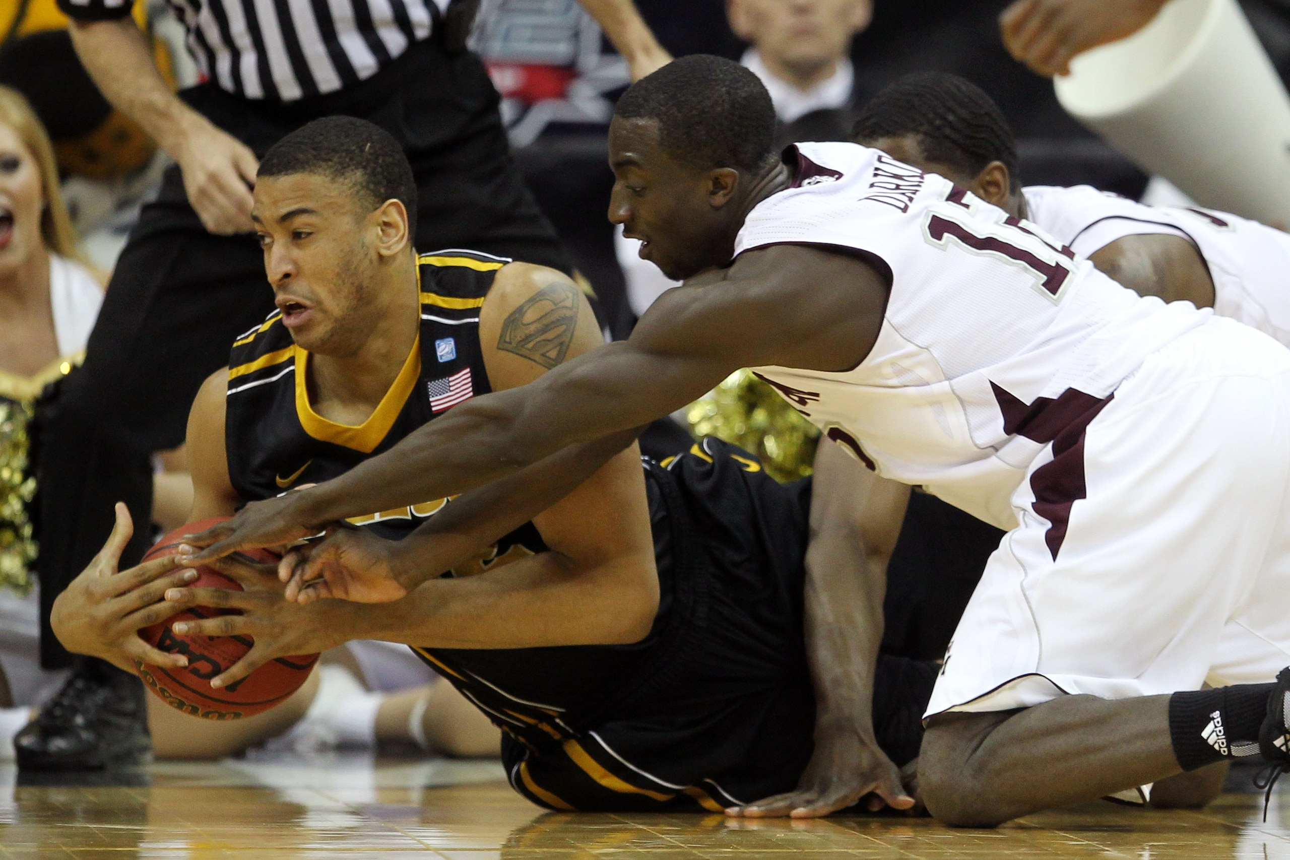 KANSAS CITY, MO - MARCH 10:  Steve Moore #32 of the Missouri Tigers fights for possesion of the ball with Andrew Darko #12 of the Texas A&M Aggies during their quarterfinal game in the 2011 Phillips 66 Big 12 Men's Basketball Tournament at Sprint Center o
