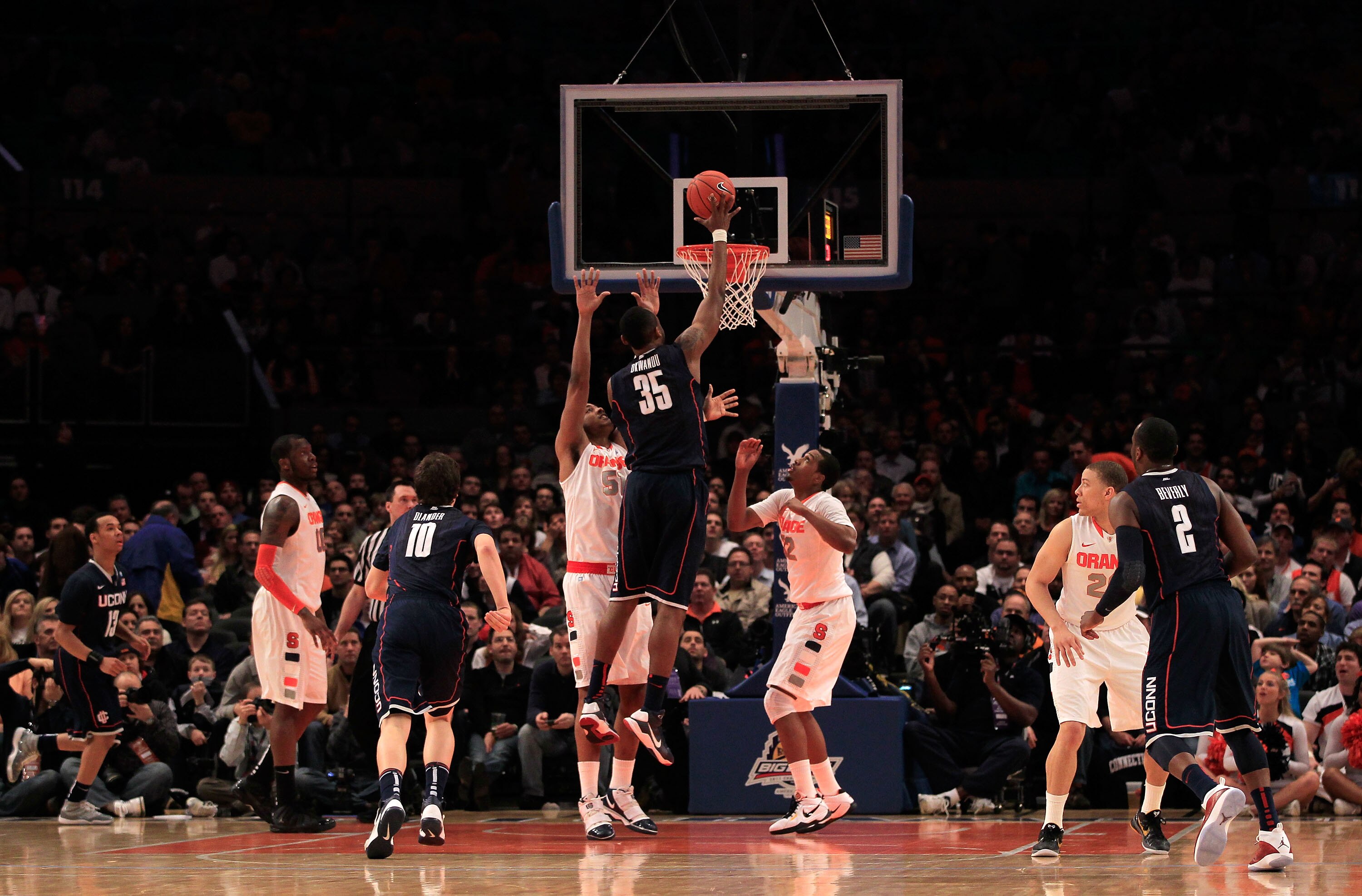 NEW YORK, NY - MARCH 11: Charles Okwandu #35 of the Connecticut Huskies shoots over Fab Melo #51 of the Syracuse Orange during the semifinals of the 2011 Big East Men's Basketball Tournament presented by American Eagle Outfitters at Madison Square Garden