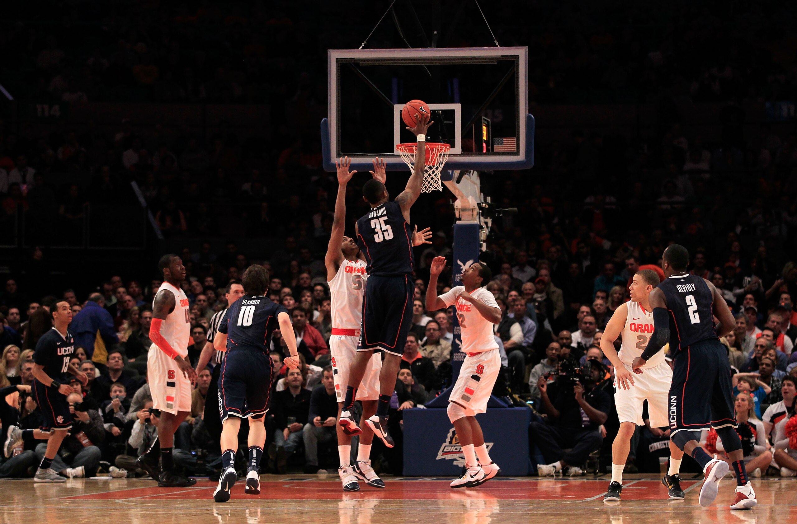 NEW YORK, NY - MARCH 11: Charles Okwandu #35 of the Connecticut Huskies shoots over Fab Melo #51 of the Syracuse Orange during the semifinals of the 2011 Big East Men's Basketball Tournament presented by American Eagle Outfitters at Madison Square Garden