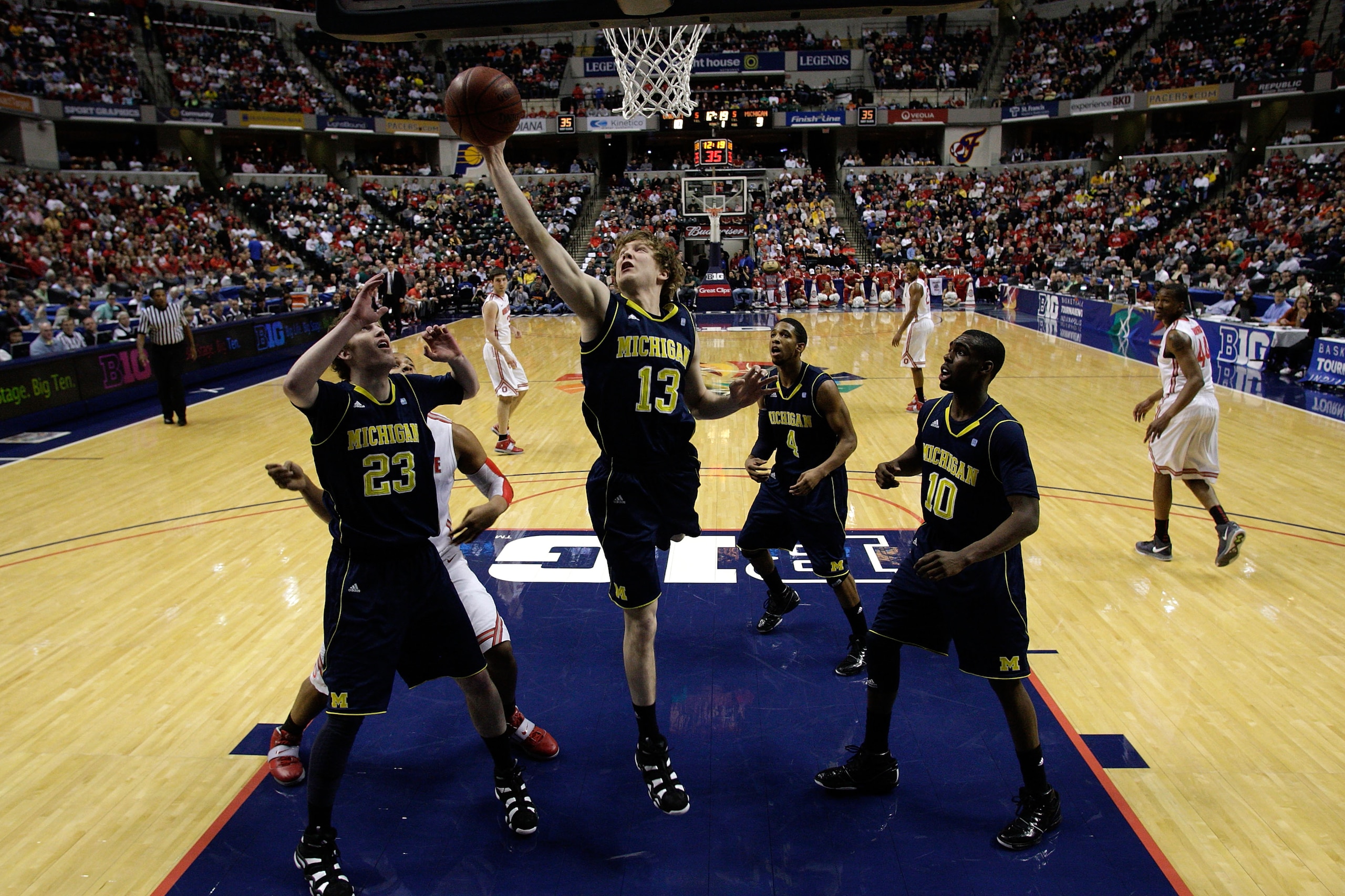 INDIANAPOLIS, IN - MARCH 12:  Matt Vogrich #13 of the Michigan Wolverines grabs a rebound against the Ohio State Buckeyes  during the semifinals of the 2011 Big Ten Men's Basketball Tournament at Conseco Fieldhouse on March 12, 2011 in Indianapolis, India