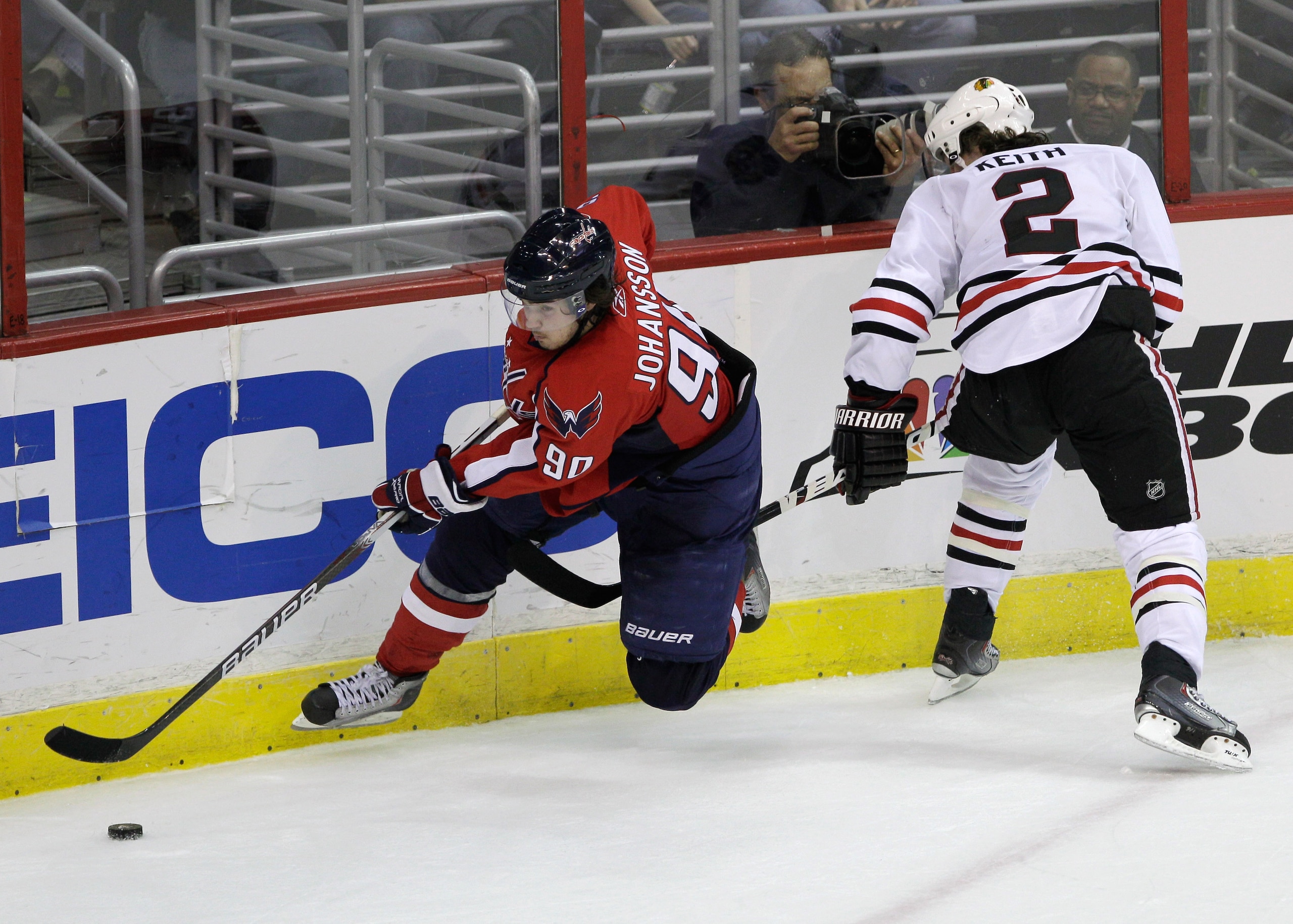 WASHINGTON, DC - MARCH 13: Marcus Johansson #90 of the Washington Capitals moves the puck in front of Duncan Keith #2 of the Chicago Blackhawks at the Verizon Center on March 13, 2011 in Washington, DC.  (Photo by Rob Carr/Getty Images)