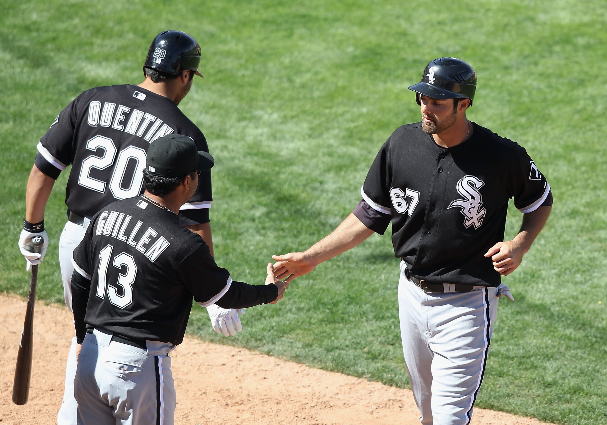 TUCSON, AZ - MARCH 07:   Jordan Danks #67 of the Chicago White Sox high fives manager Ozzie Guillen after Danks scored a run against the Arizona Diamondbacks during the fifth inning of the spring training game at Kino Veterans Memorial Stadium on March 7,