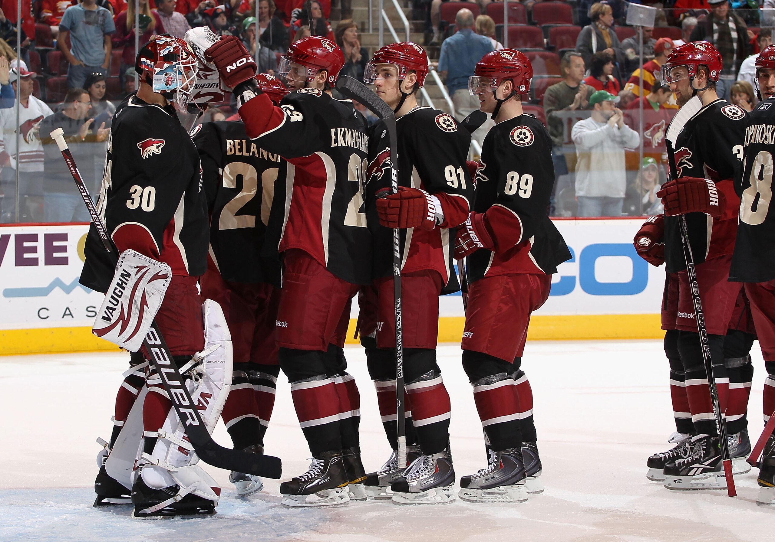 GLENDALE, AZ - MARCH 10:  Goaltender Ilya Bryzgalov #30 of the Phoenix Coyotes celebrates with teammates following the NHL game against the Calgary Flames at Jobing.com Arena on March 10, 2011 in Glendale, Arizona.  The Coyotes defeated the Flames 3-0.  (