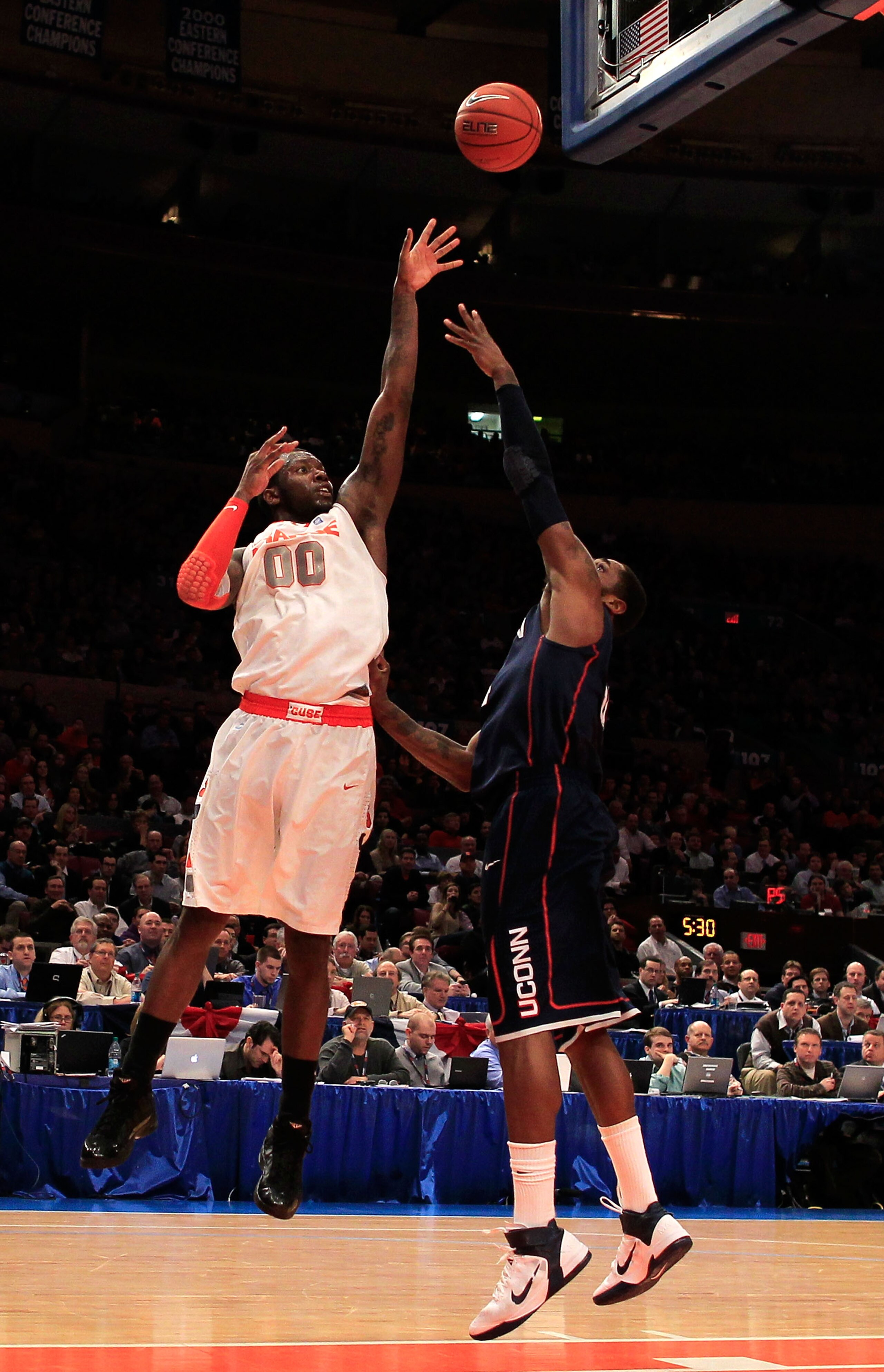 NEW YORK, NY - MARCH 11: Rick Jackson #0 of the Syracuse Orange shoots over Alex Oriakhi #34 of the Connecticut Huskies during the semifinals of the 2011 Big East Men's Basketball Tournament presented by American Eagle Outfitters at Madison Square Garden