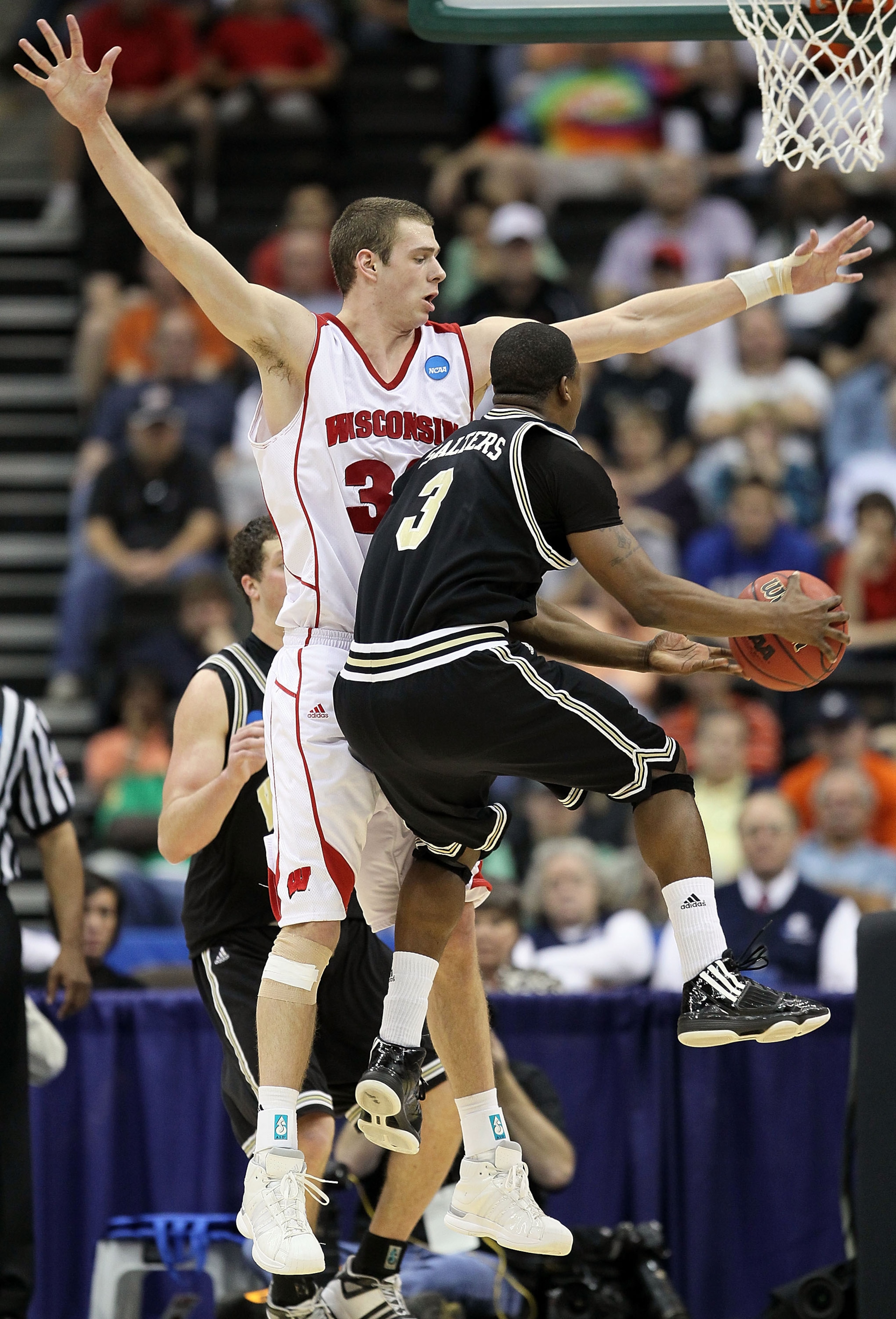 JACKSONVILLE, FL - MARCH 19:  Jon Leuer #30 of the Wisconsin Badgers defends the shot of Junior Salters # 3of the Wofford Terriers during the first round of the 2010 NCAA men's basketball tournament at Jacksonville Veteran's Memorial Arena on March 19, 20
