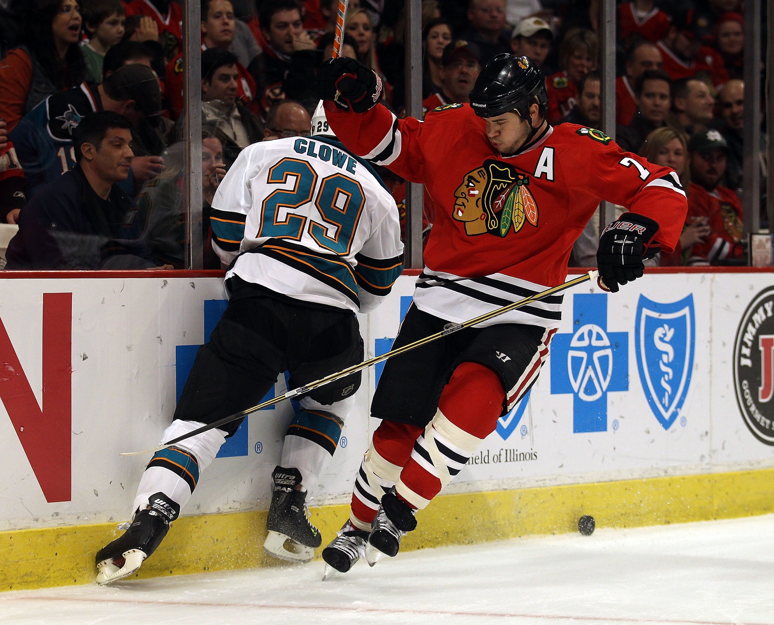 CHICAGO, IL - DECEMBER 30: Brent Seabrook #7 of the Chicago Blackhawks shoves Ryane Clowe #29 of the San Jose Sharks as they battle for the puck at the United Center on December 30, 2010 in Chicago, Illinois. The Sharks defeated the Blackhawks 5-3.  (Phot