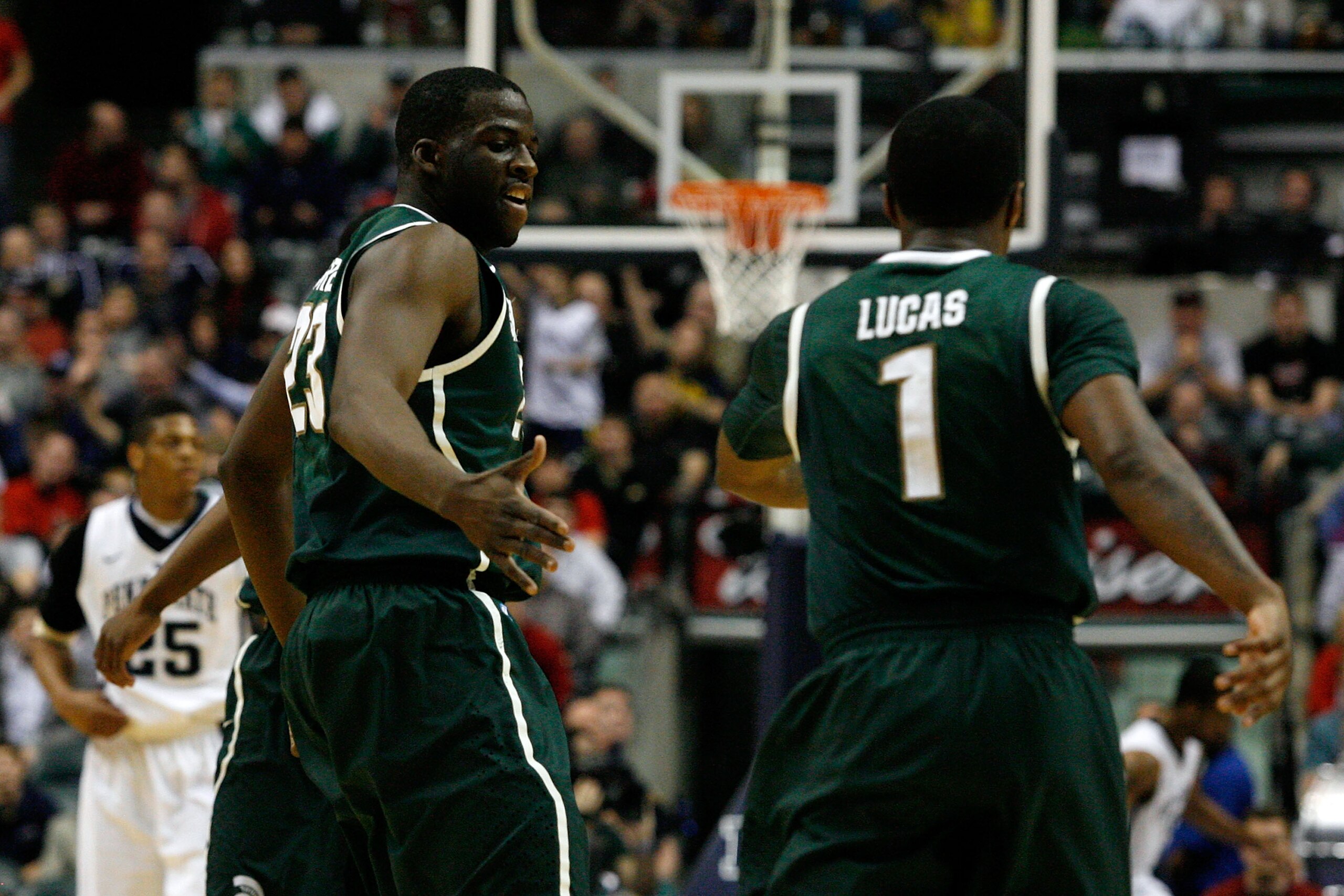 INDIANAPOLIS, IN - MARCH 12:  (L-R) Draymond Green #23 and Kalin Lucas #1 of the Michigan State Spartans react to a Michigan State Spartans basket in the first half against the Penn State Nittany Lions during the semifinals of the 2011 Big Ten Men's Baske