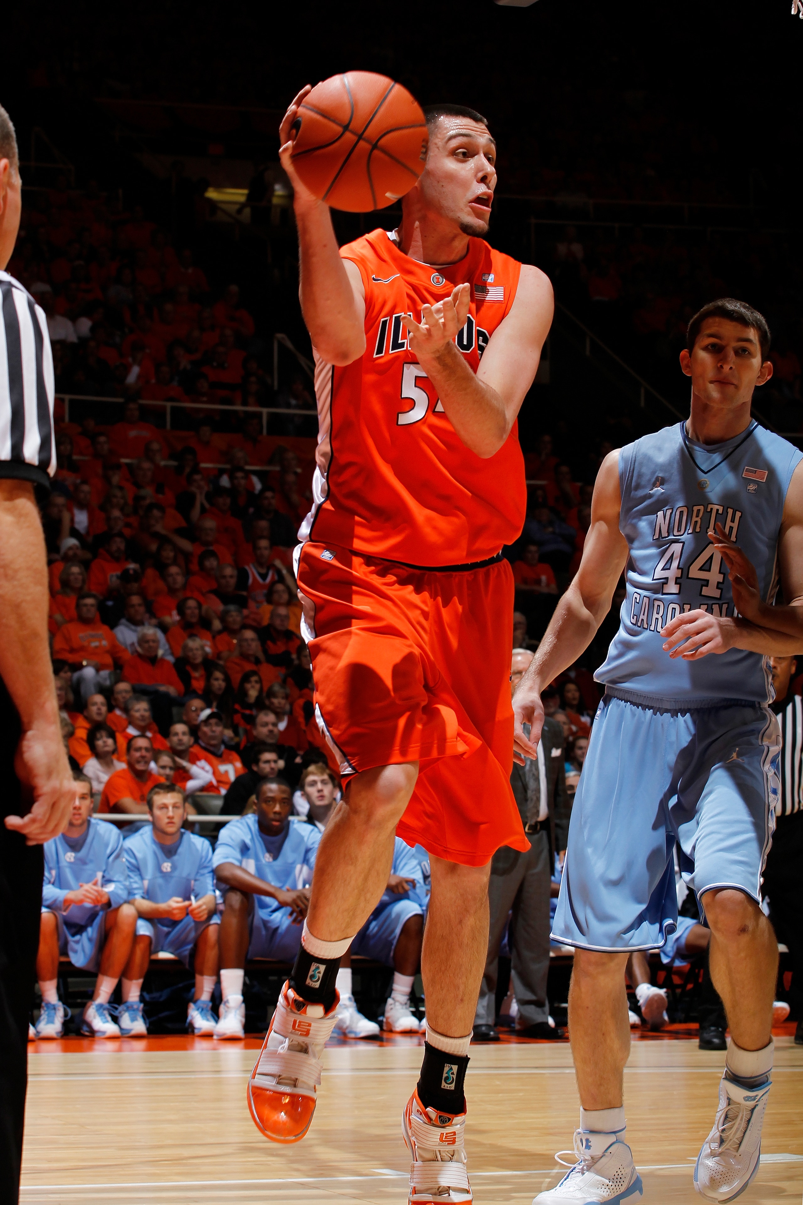 CHAMPAIGN, IL - NOVEMBER 30: Mike Tisdale #54 of the Illinois Fighting Illini saves the basketball from going out of bounds against the North Carolina Tar Heels during the 2010 ACC/Big Ten Challenge at Assembly Hall on November 30, 2010 in Champaign, Illi