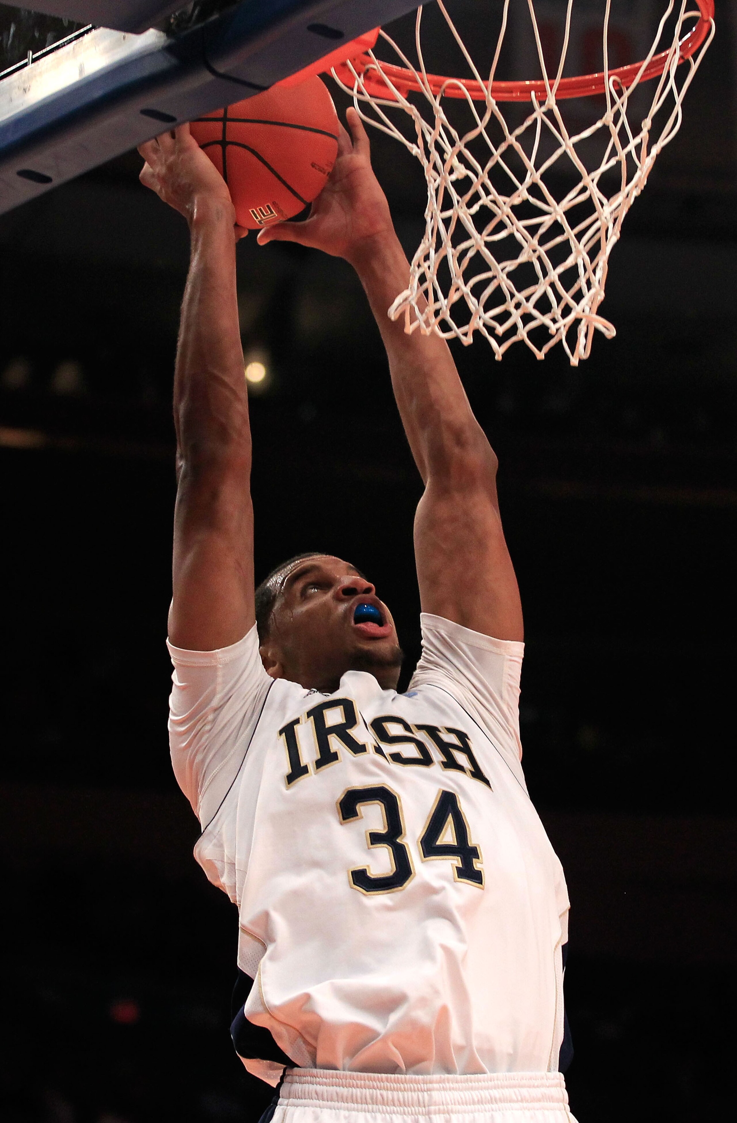 NEW YORK, NY - MARCH 10: Carleton Scott #34 of the Notre Dame Fighting Irish goes up for a dunk against the Cincinnati Bearcats during the quarterfinals of the 2011 Big East Men's Basketball Tournament presented by American Eagle Outfitters  at Madison Sq