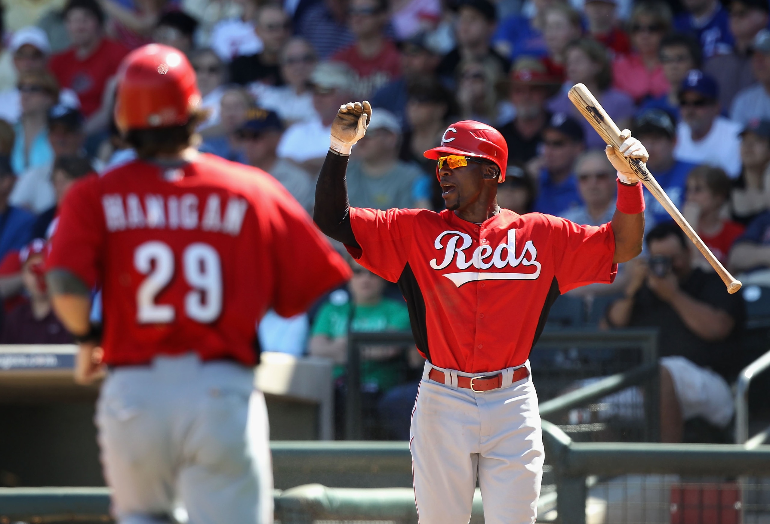 SURPRISE, AZ - MARCH 11:  Fred Lewis #15 of the Cincinnati Reds reacts as Ryan Hanigan #29 scores a run against the Texas Rangers during the second inning of the spring training game at Surprise Stadium on March 11, 2011 in Surprise, Arizona.  (Photo by C