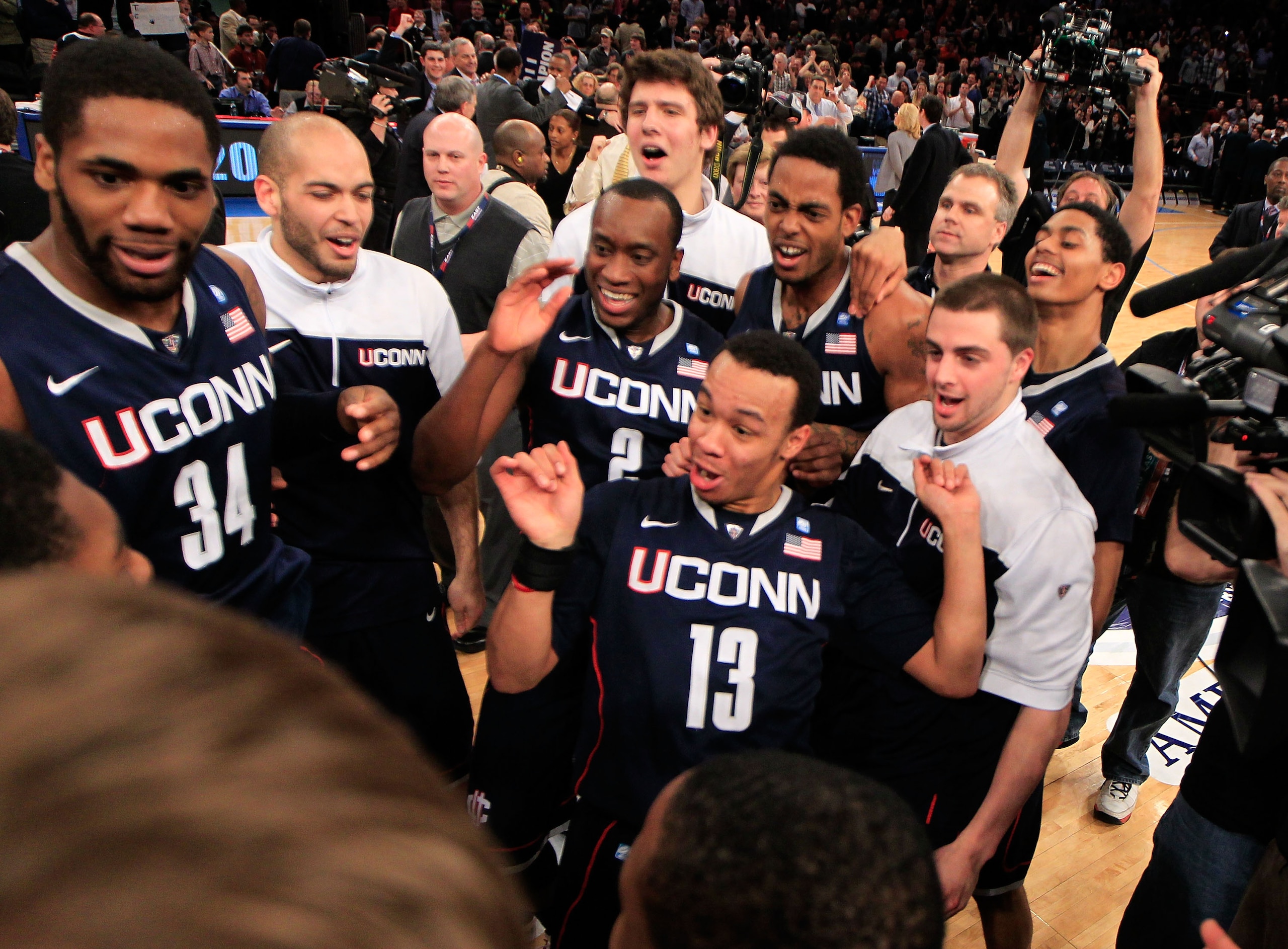 NEW YORK, NY - MARCH 12: Shabazz Napier #13 of the Connecticut Huskies celebrates with teammates after defeating the Louisville Cardinals during the championship of the 2011 Big East Men's Basketball Tournament presented by American Eagle Outfitters at Ma