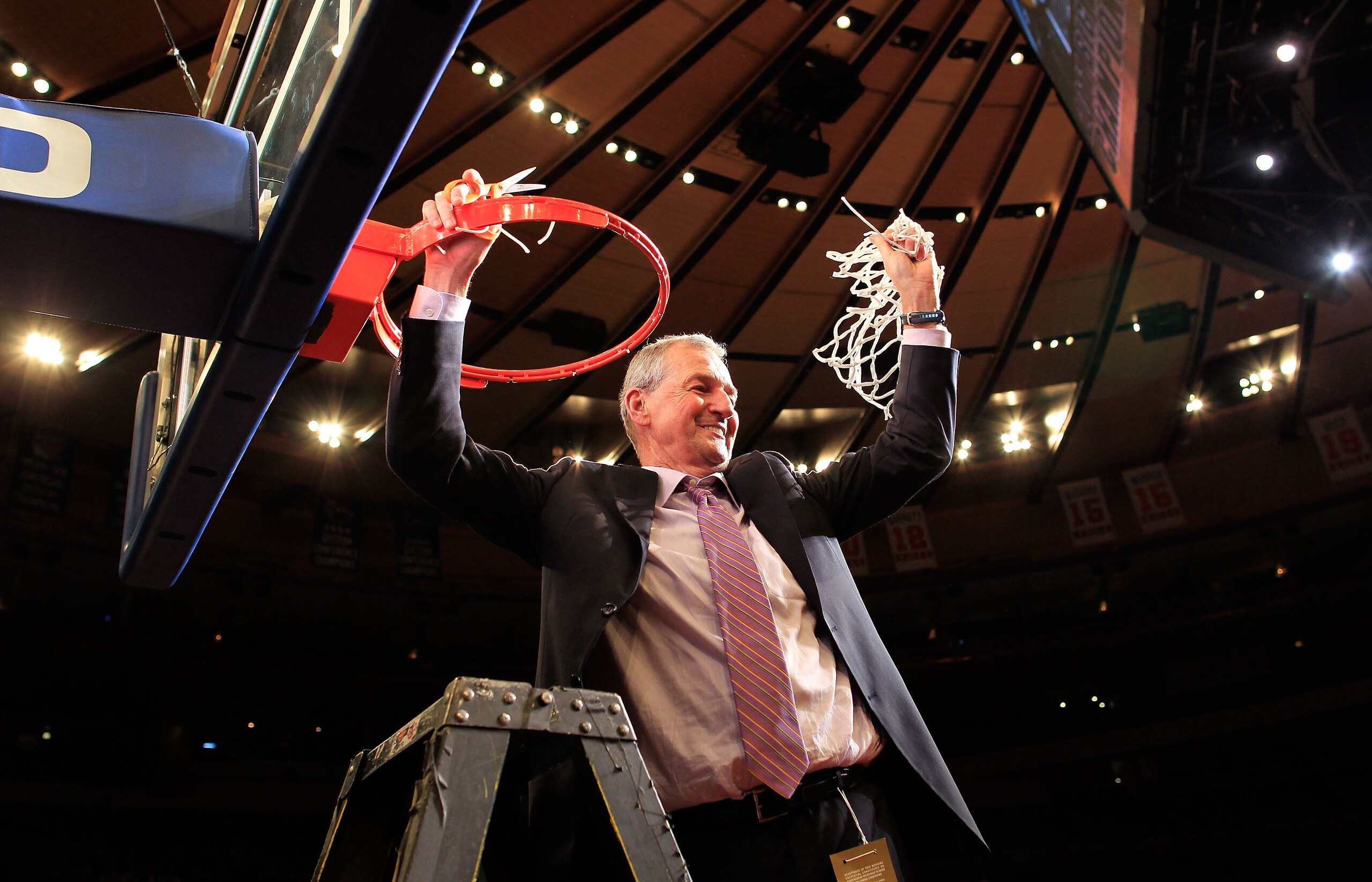 NEW YORK, NY - MARCH 12: Head coach Jim Calhoun of the Connecticut Huskies cuts down the net after defeating the Louisville Cardinals during the championship of the 2011 Big East Men's Basketball Tournament presented by American Eagle Outfitters at Madiso