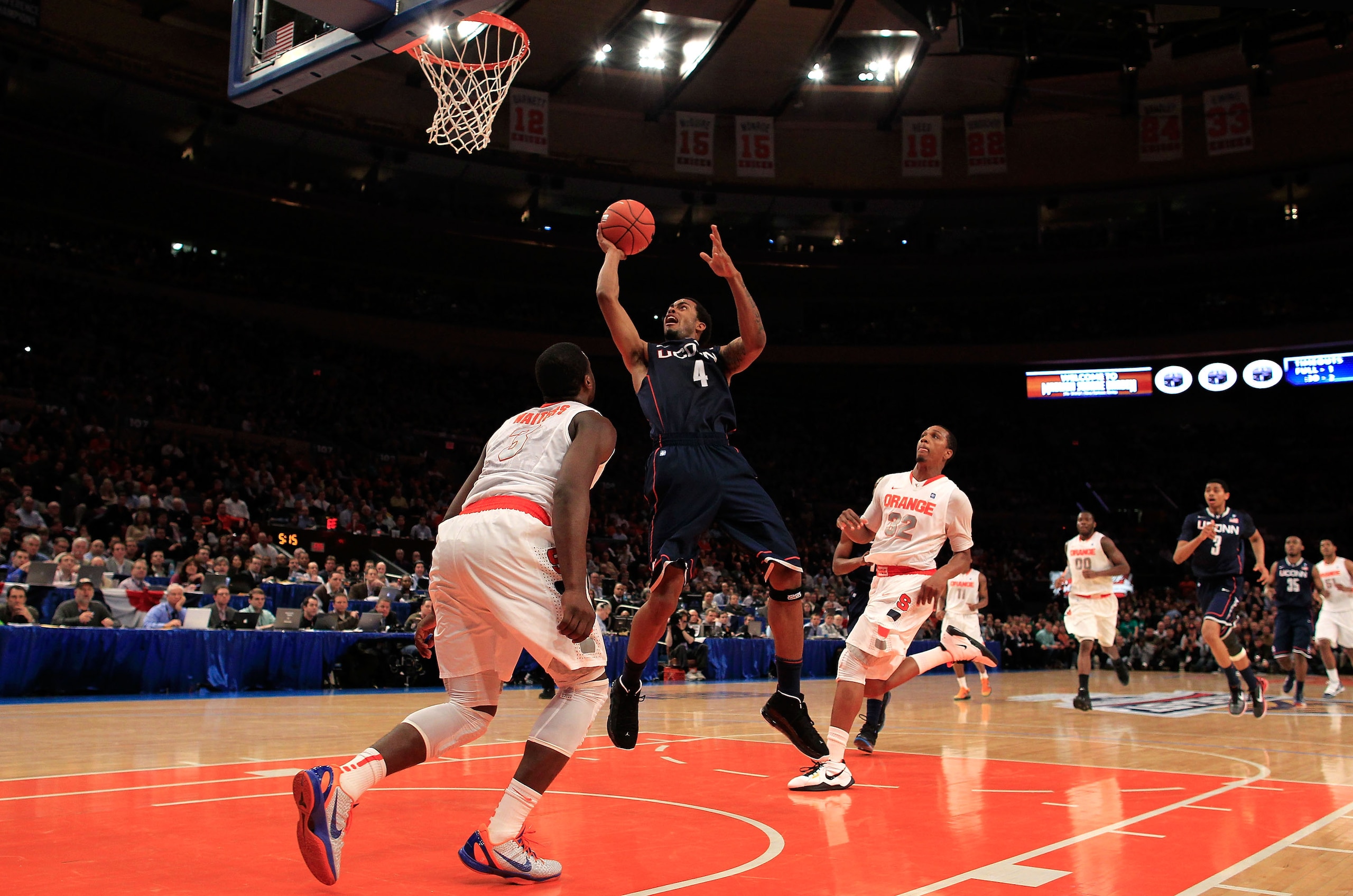 NEW YORK, NY - MARCH 11: Jamal Coombs-McDaniel #4 of the Connecticut Huskies shoots over Dion Waiters #3 of the Syracuse Orange during the semifinals of the 2011 Big East Men's Basketball Tournament presented by American Eagle Outfitters at Madison Square