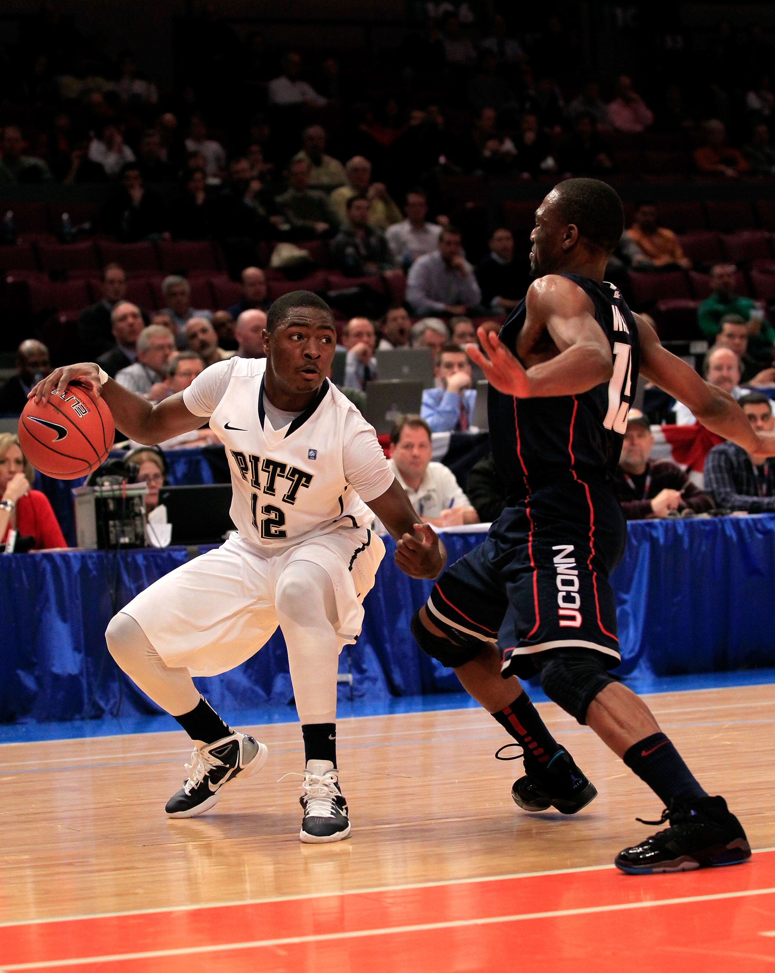 NEW YORK, NY - MARCH 10: Ashton Gibbs #12 of the Pittsburgh Panthers handles the ball against Kemba Walker #15 of the Connecticut Huskies during the quarterfinals of the 2011 Big East Men's Basketball Tournament presented by American Eagle Outfitters  at