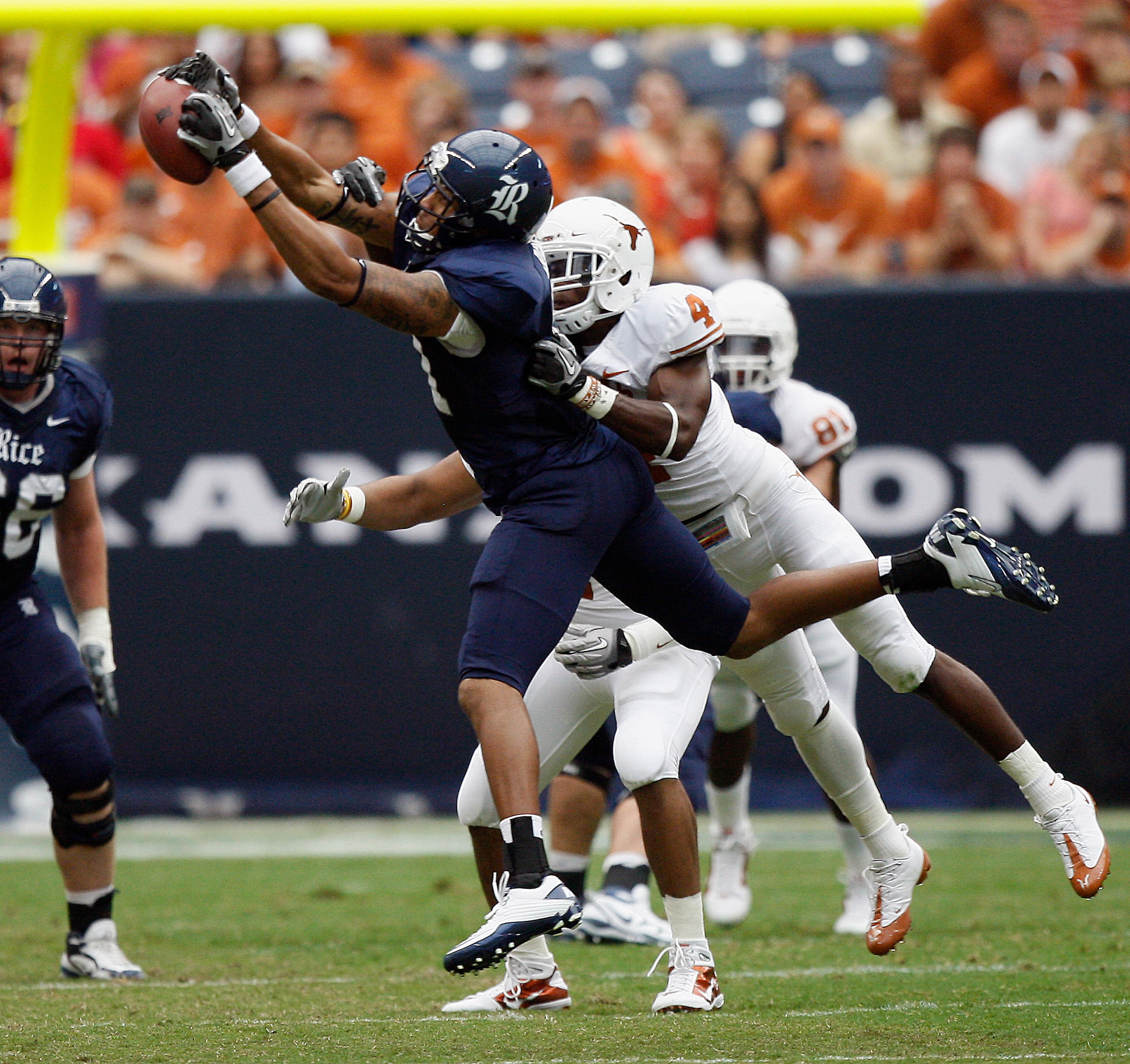 HOUSTON - SEPTEMBER 04: Wide receiver Pierre Beasley #11 of the Rice Owls makes a catch in front of cornerback Aaron Williams #4 of the Texas Longhorns at Reliant Stadium on September 4, 2010 in Houston, Texas. (Photo by Bob Levey/Getty Images) HOUSTON - SEPTEMBER 04: Wide receiver Pierre Beasley #11 of the Rice Owls makes a catch in front of cornerback Aaron Williams #4 of the Texas Longhorns at Reliant Stadium on September 4, 2010 in Houston, Texas. (Photo by Bob Levey/Getty Images)