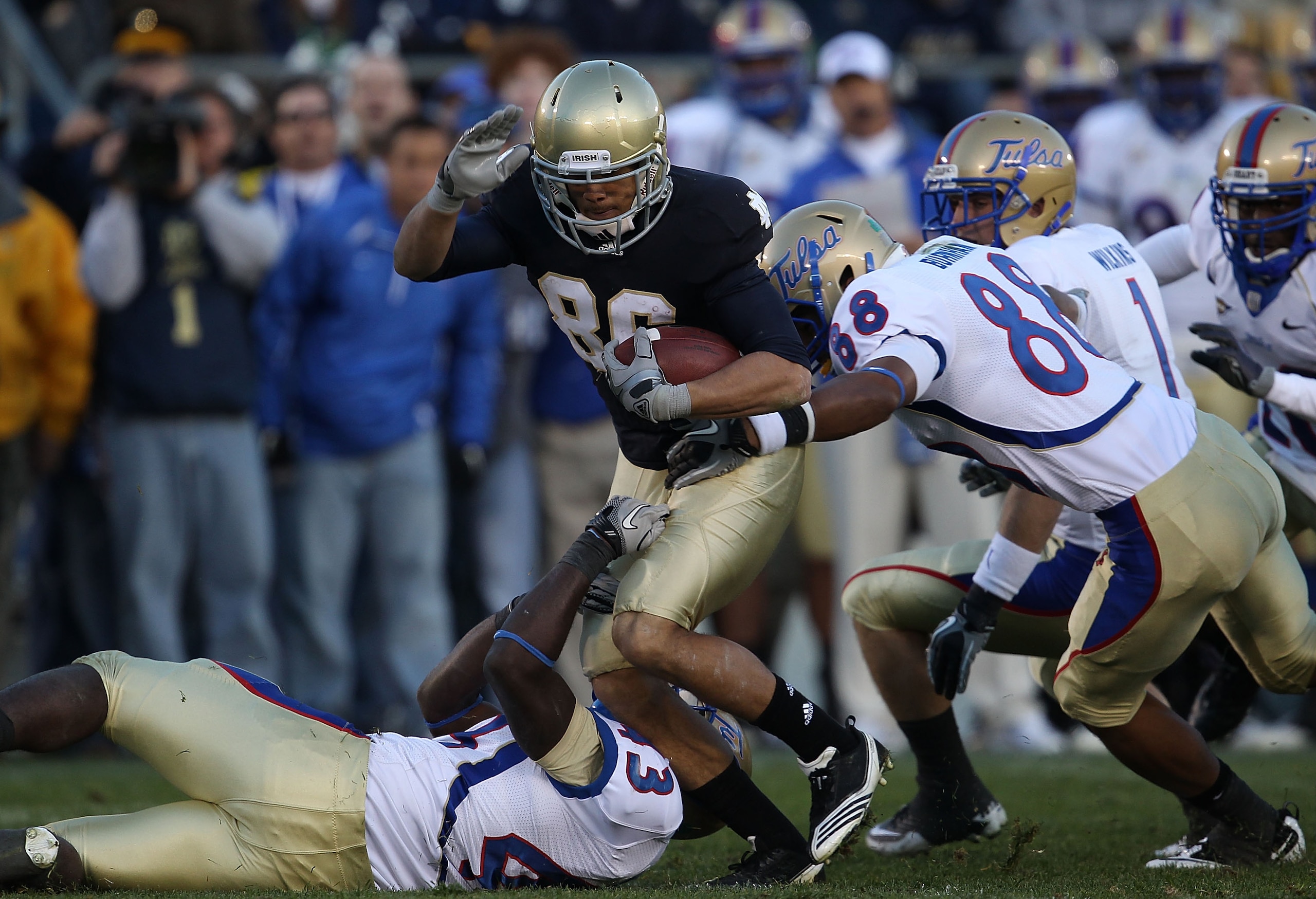 SOUTH BEND, IN - OCTOBER 30: Bennett Jackson #86 of the Notre Dame Fighting Irish is tackled by Donnell Hawkins #43 and Bryan Burnham #88 of the Tulsa Golden Hurricane at Notre Dame Stadium on October 30, 2010 in South Bend, Indiana. Tulsa defeated Notre SOUTH BEND, IN - OCTOBER 30: Bennett Jackson #86 of the Notre Dame Fighting Irish is tackled by Donnell Hawkins #43 and Bryan Burnham #88 of the Tulsa Golden Hurricane at Notre Dame Stadium on October 30, 2010 in South Bend, Indiana. Tulsa defeated Notre