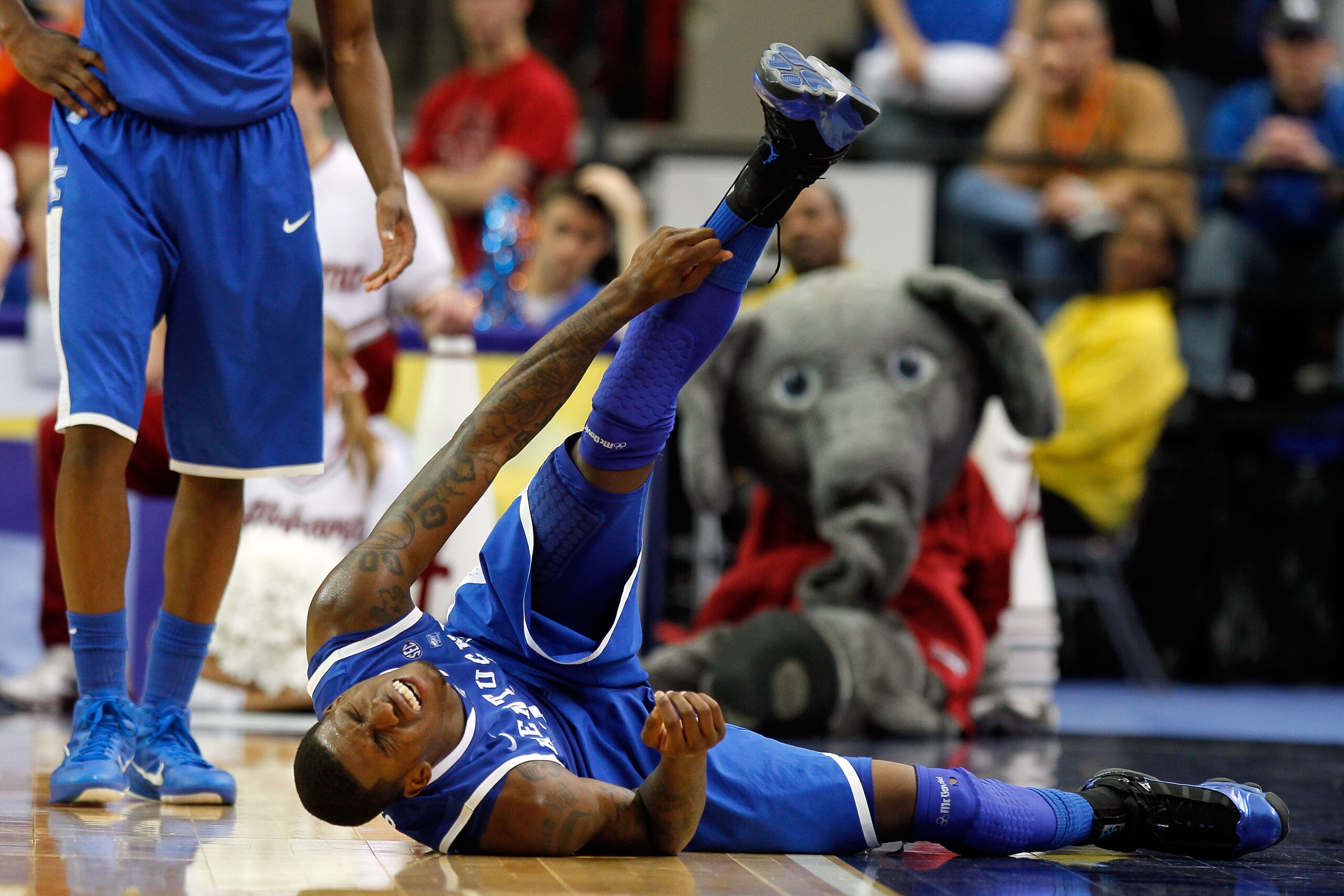 ATLANTA, GA - MARCH 12:  DeAndre Liggins #34 of the Kentucky Wildcats lies on the court injured during their game against the Alabama Crimson Tide in the semifinals of the SEC Men's Basketball Tournament at Georgia Dome on March 12, 2011 in Atlanta, Georg
