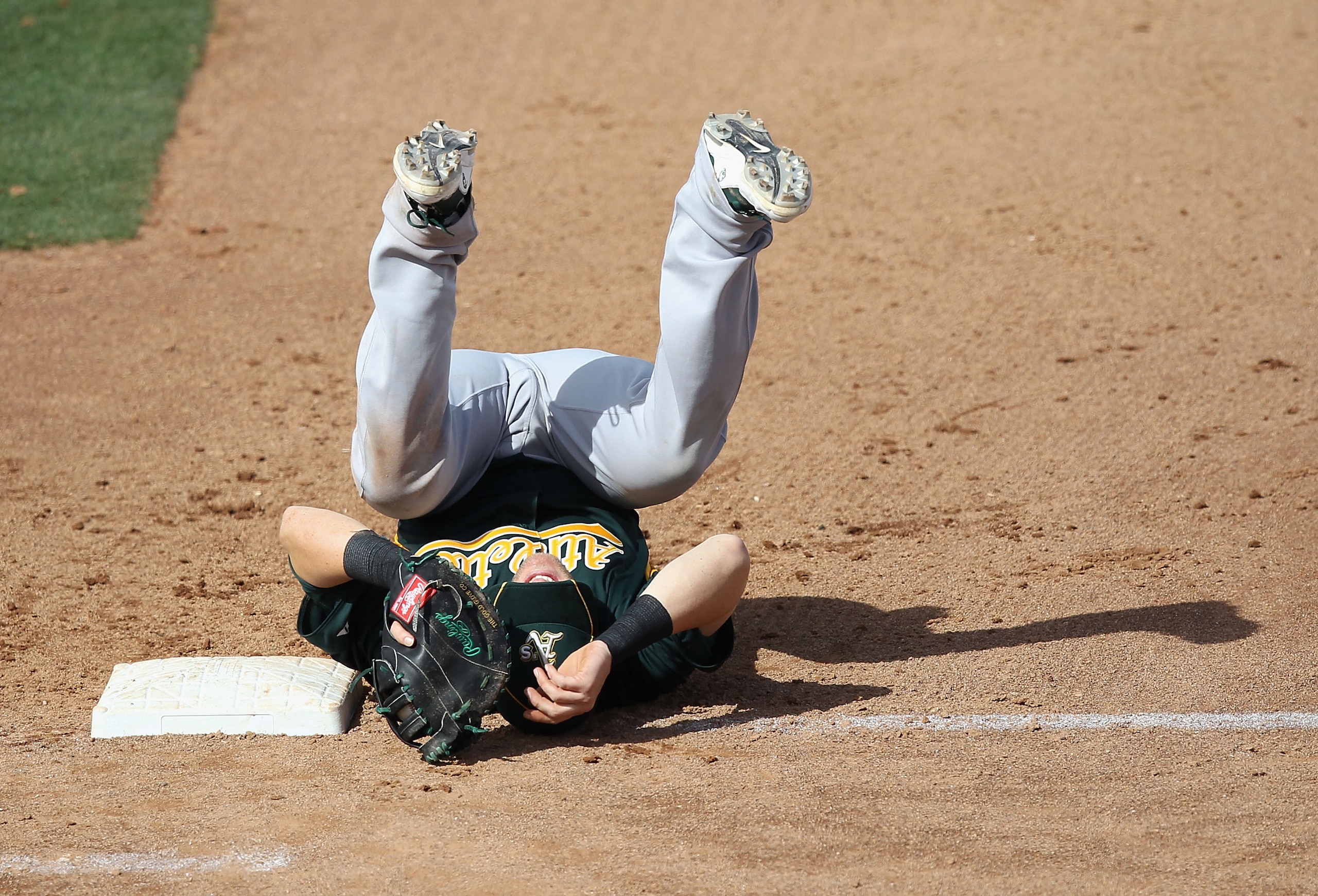 PEORIA, AZ - MARCH 06: Infielder Daric Barton #10 of the Oakland Athletics lands on his back after a collision with Logan Forsythe (not pictured) of the San Diego Padres during the third inning of the spring training game at Peoria Stadium on March 6, 20 PEORIA, AZ - MARCH 06: Infielder Daric Barton #10 of the Oakland Athletics lands on his back after a collision with Logan Forsythe (not pictured) of the San Diego Padres during the third inning of the spring training game at Peoria Stadium on March 6, 20