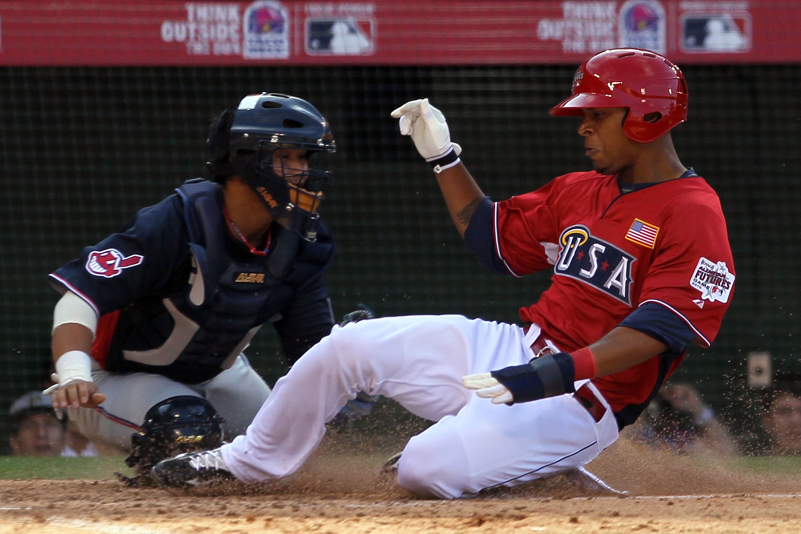 ANAHEIM, CA - JULY 11:  World Futures All-Star Chun Chen #29 of the Clevland Indians braces as U.S. Futures All-Star Desmond Jennings #15 of the Tampa Bay Rays slides to score a run during the 2010 XM All-Star Futures Game at Angel Stadium of Anaheim on J