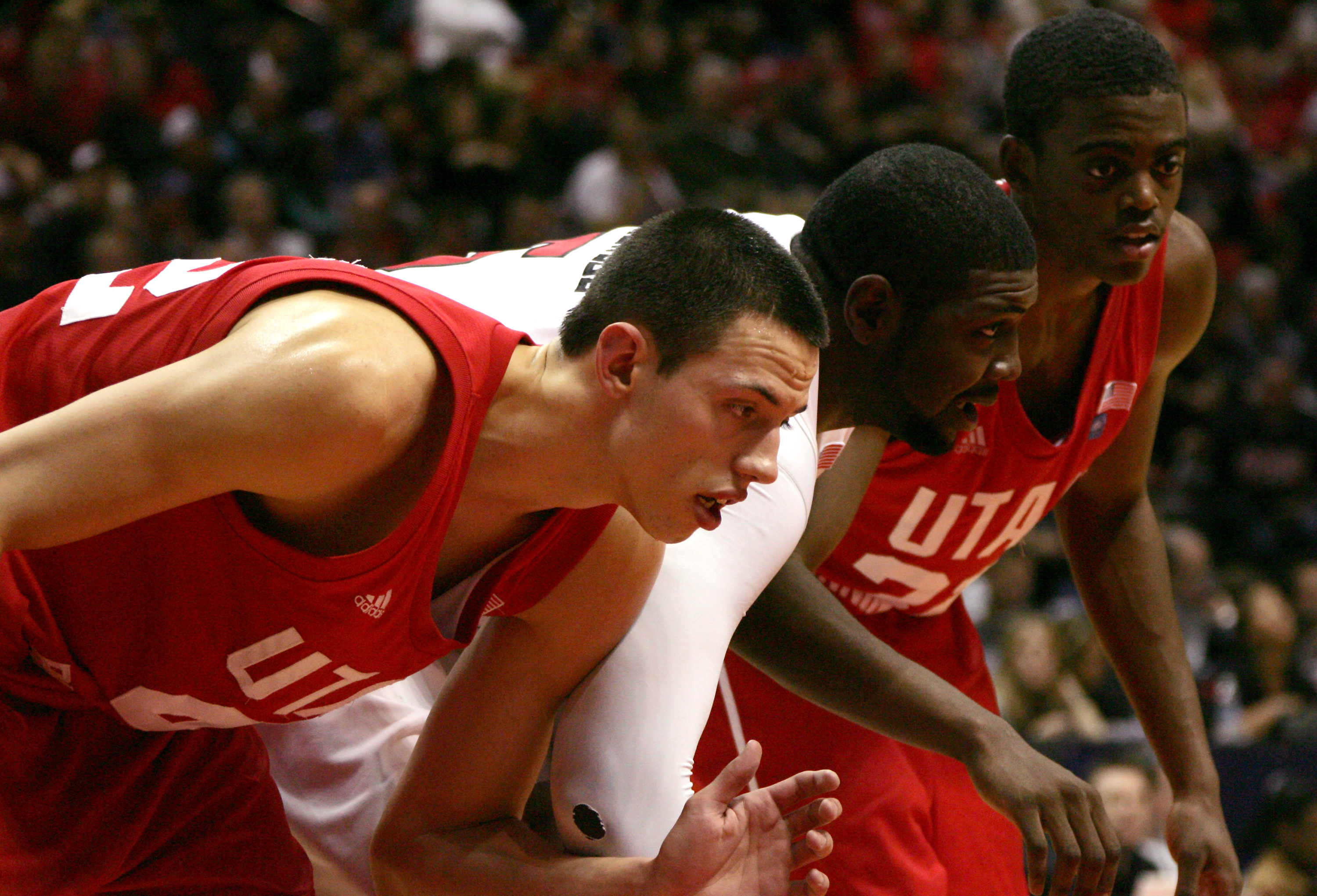 SAN DIEGO, CA - FEBRUARY 8: Brian Carlwell #5 (center) of San Diego State fights for position during a free throw attempt against Jason Washburn #42 (left) and Will Clyburn #21 (right) of Utah on February 8, 2011 at Cox Arena in San Diego, California. SDS