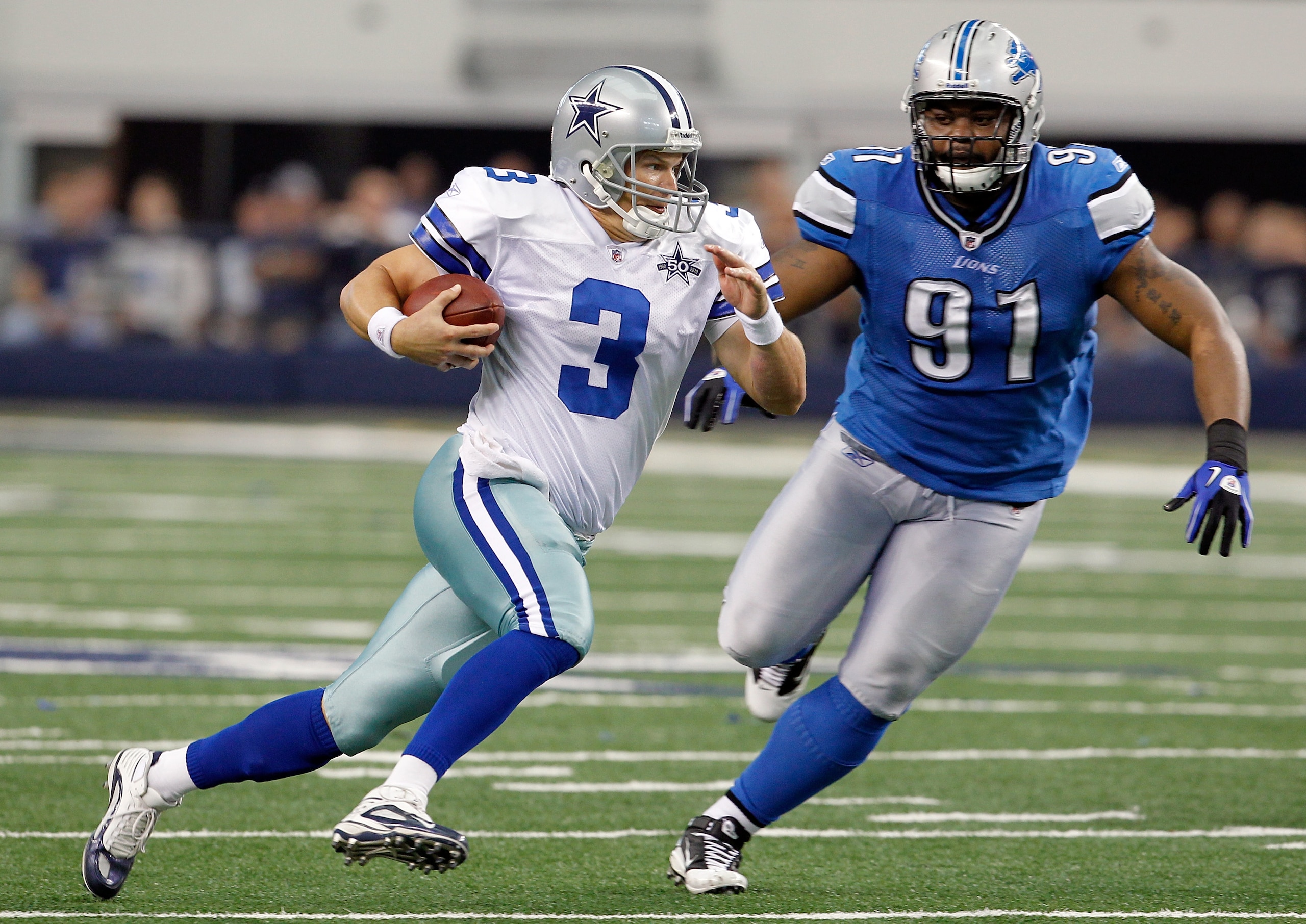 ARLINGTON, TX - NOVEMBER 21:  Quarterback Jon Kitna #3 of the Dallas Cowboys scrambles with the ball against tackle Sammie Hill #91 of the Detroit Lions at Cowboys Stadium on November 21, 2010 in Arlington, Texas.  The Cowboys beat the Lions 35-19.  (Phot