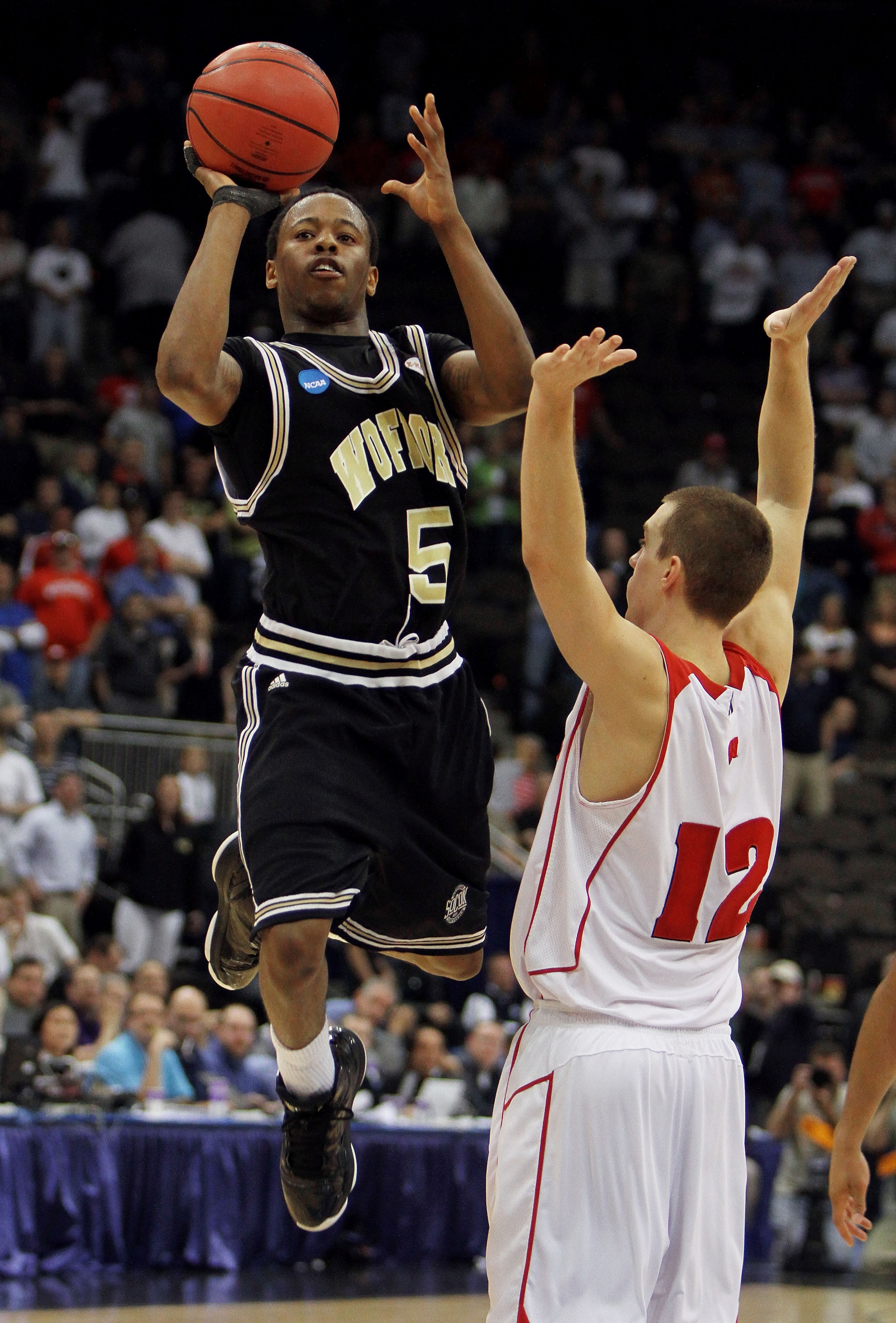 JACKSONVILLE, FL - MARCH 19:  Jamar Diggs #5 of the Wofford Terriers takes a desperation shot attempt over Jason Bohannon #12 of the Wisconsin Badgers during the first round of the 2010 NCAA men's basketball tournament at Jacksonville Veteran's Memorial A