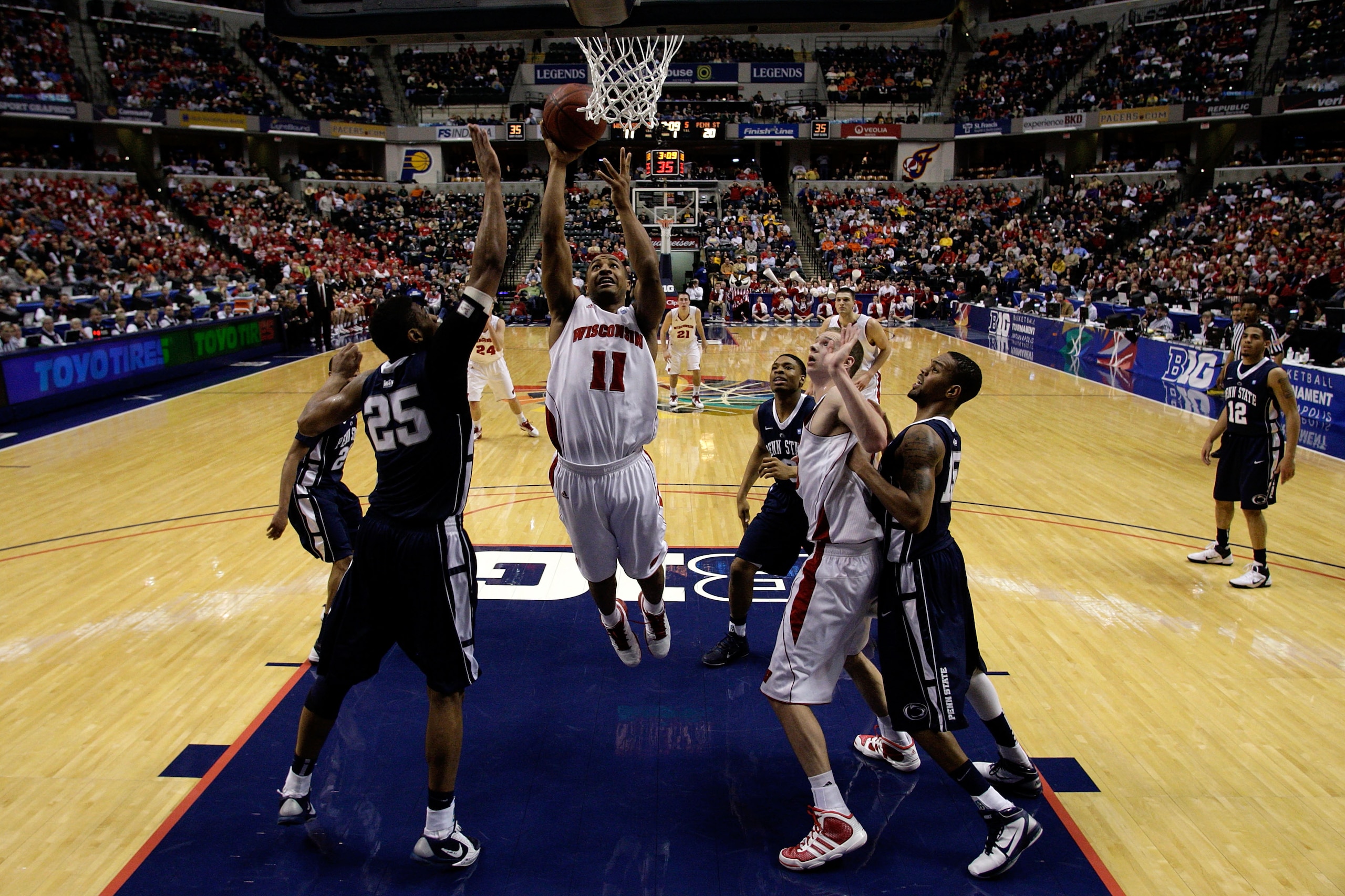 INDIANAPOLIS, IN - MARCH 11:  Jordan Taylor #11 of the Wisconsin Badgers drives for a shot attempt against the Penn State Nittany Lions during the quarterfinals of the 2011 Big Ten Men's Basketball Tournament at Conseco Fieldhouse on March 11, 2011 in Ind