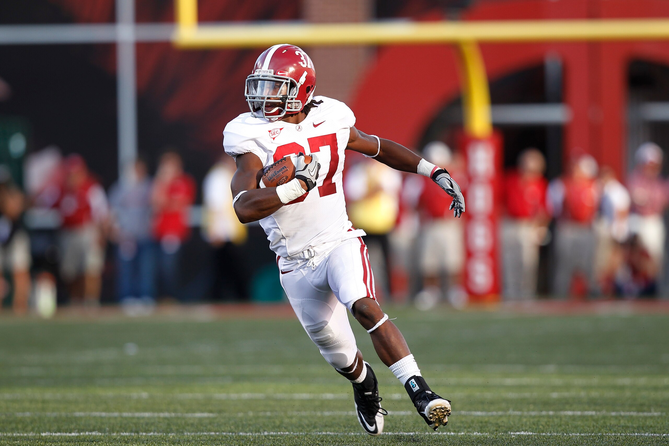 FAYETTEVILLE - SEPTEMBER 25: Robert Lester #37 of the Alabama Crimson Tide returns an interception to set up the game winning score against the Arkansas Razorbacks at Donald W. Reynolds Razorback Stadium on September 25, 2010 in Fayetteville, Arkansas. Al