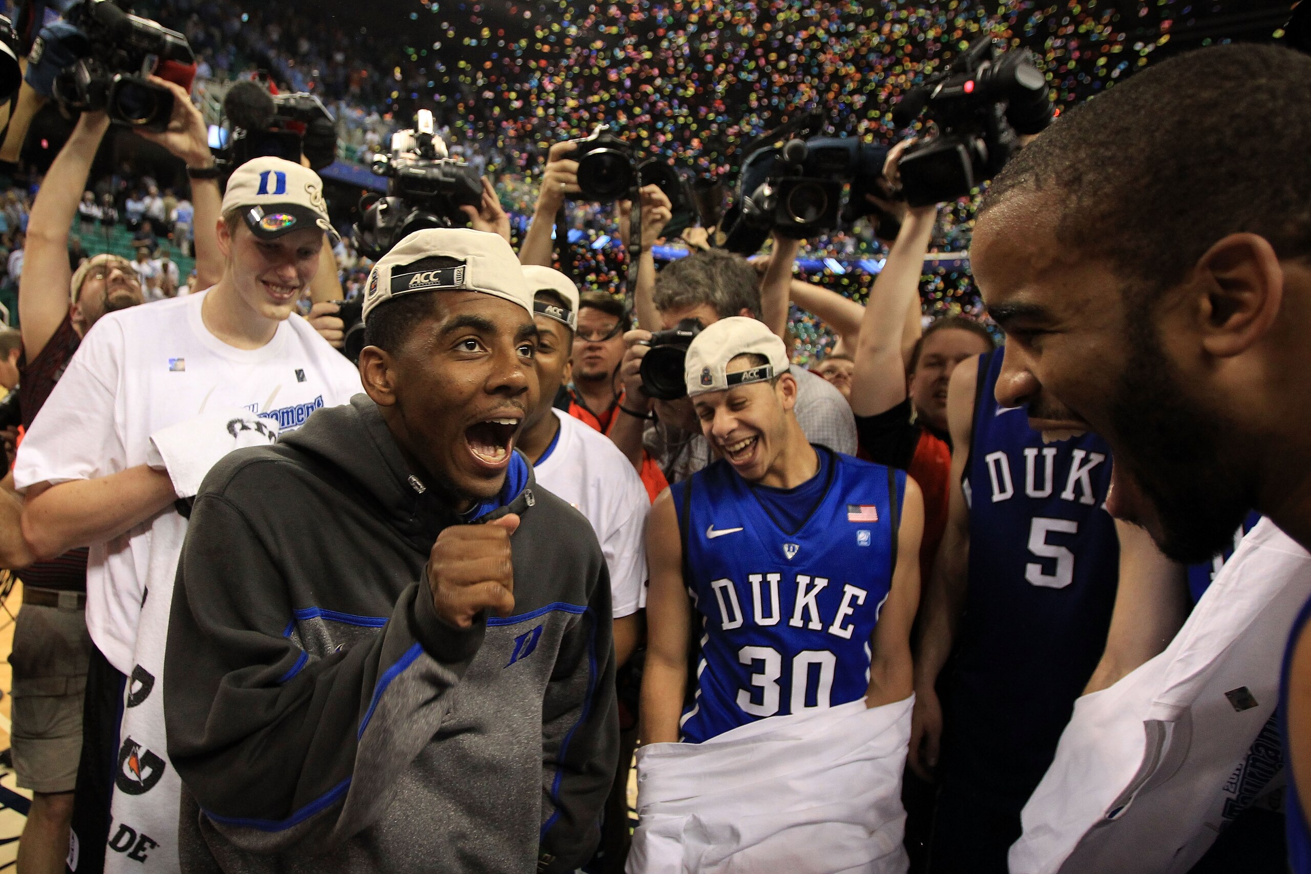 GREENSBORO, NC - MARCH 13:  Kyrie Irving #1 of the Duke Blue Devils celebrates with teammates after their 75-58 victory over the North Carolina Tar Heels to win the championship game of the 2011 ACC men's basketball tournament at the Greensboro Coliseum o