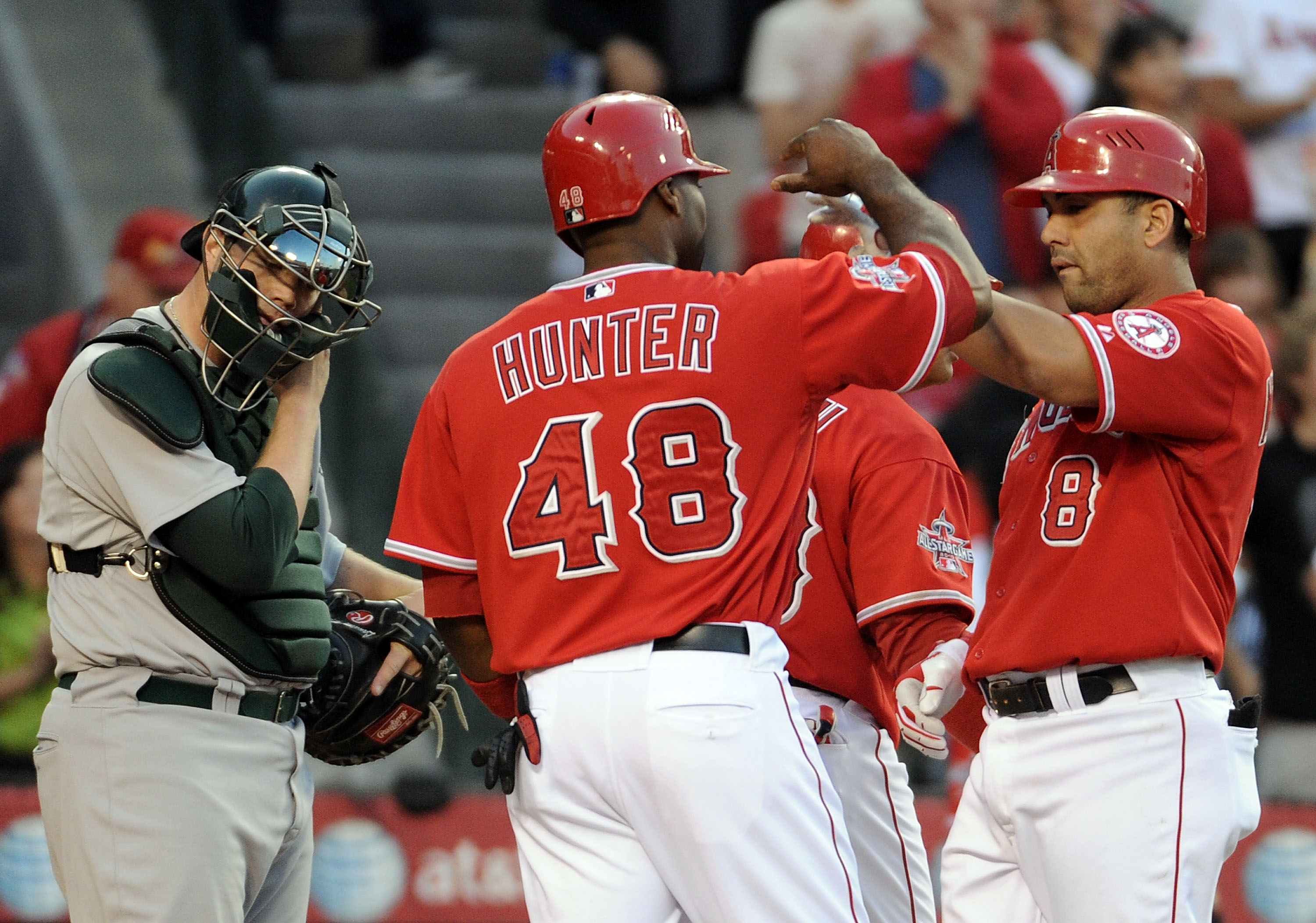 ANAHEIM, CA - MAY 15:  Landon Powell #35 of the Oakland Athletics reacts as Kendry Morales #8 and Torii Hunter #48 of the Los Angeles Angels celebrate a three run homerun during the fourth inning at Angels Stadium on May 15, 2010 in Anaheim, California.