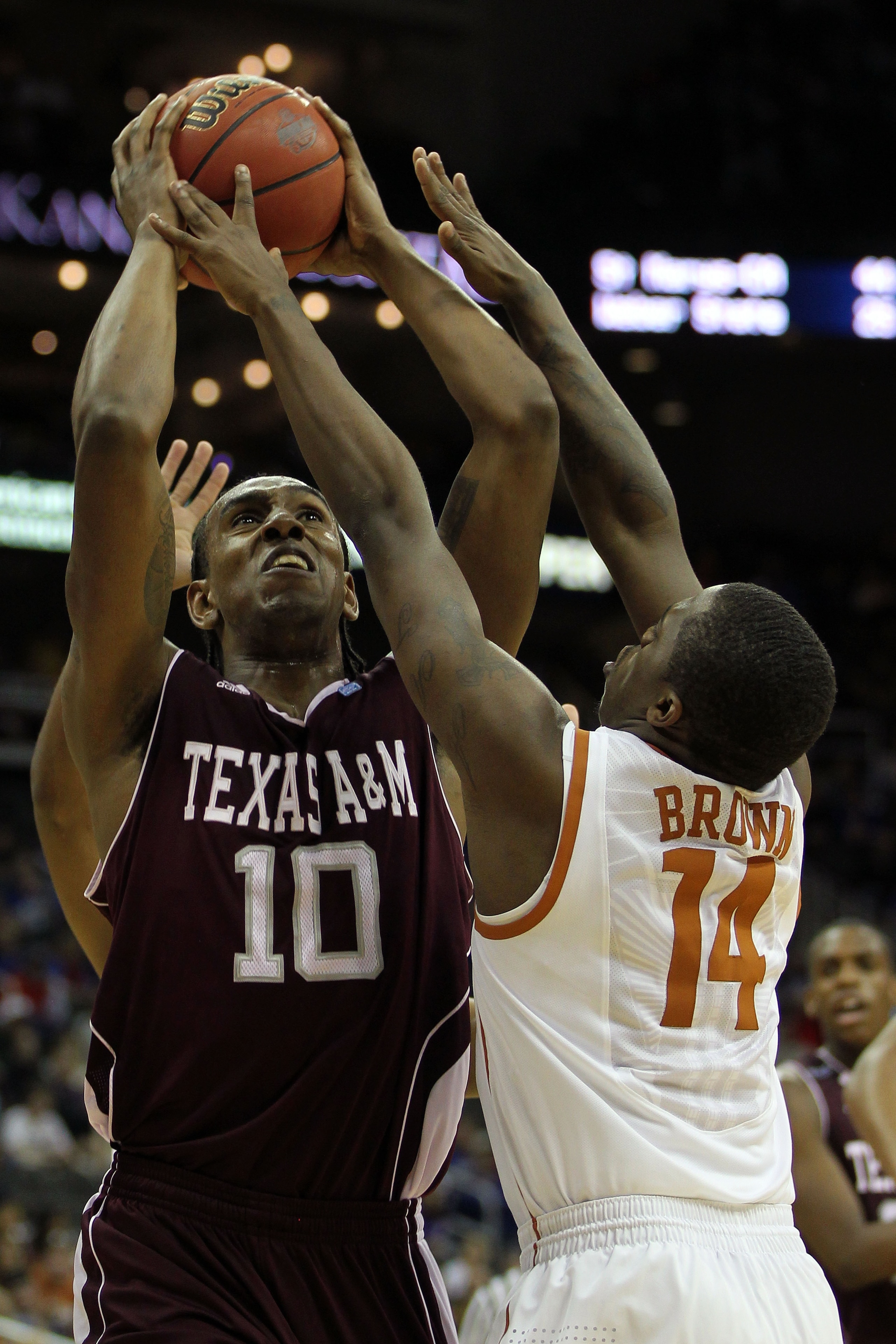 KANSAS CITY, MO - MARCH 11:  David Loubeau #10 of the Texas A&M Aggies goes up for a shot against J'Covan Brown #14 of the Texas Longhorns during their semifinal game in the 2011 Phillips 66 Big 12 Men's Basketball Tournament at Sprint Center on March 11,