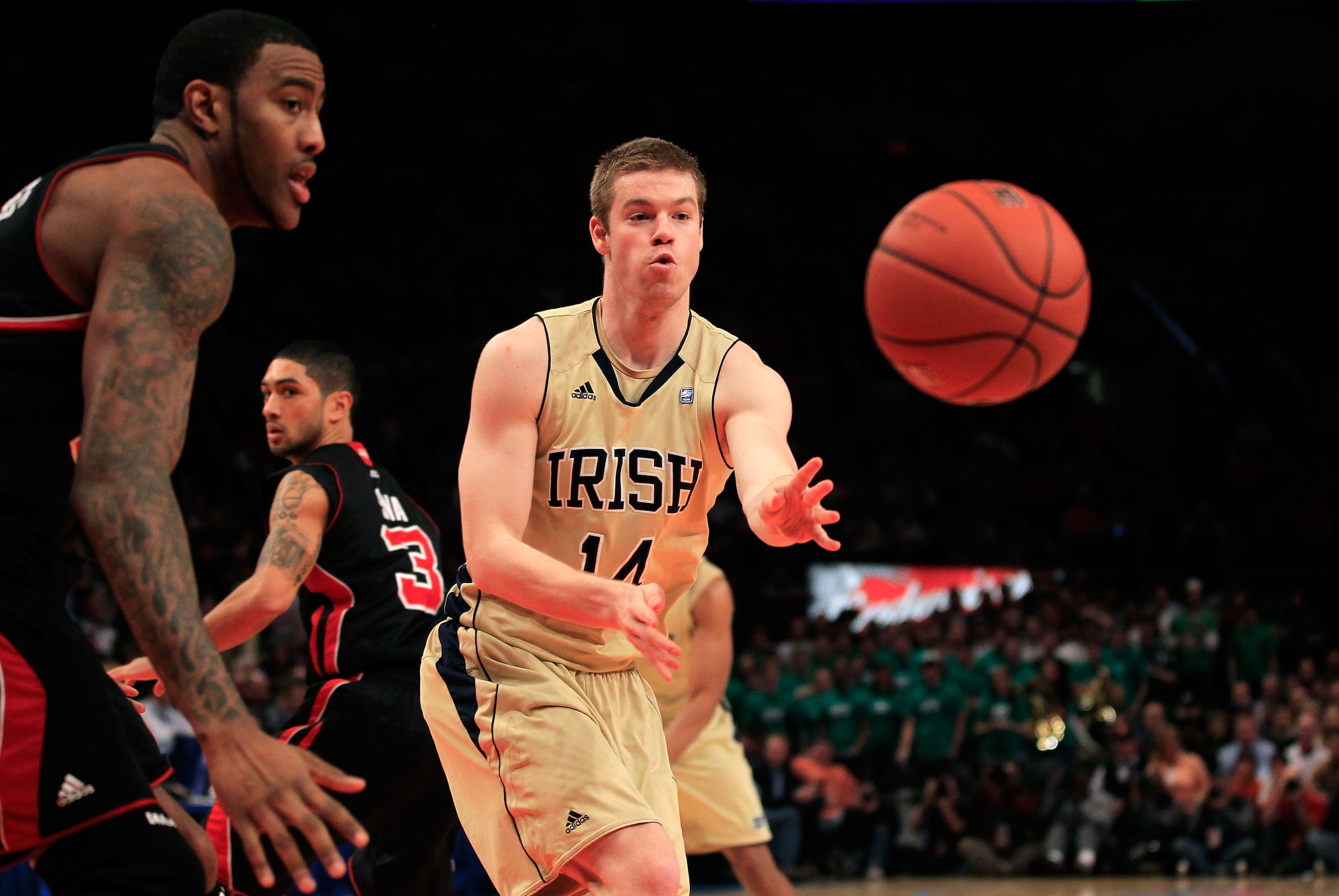 NEW YORK, NY - MARCH 11: Scott Martin #14 of the Notre Dame Fighting Irish passes the ball against the Louisville Cardinals during the semifinals of the 2011 Big East Men's Basketball Tournament presented by American Eagle Outfitters at Madison Square Gar NEW YORK, NY - MARCH 11: Scott Martin #14 of the Notre Dame Fighting Irish passes the ball against the Louisville Cardinals during the semifinals of the 2011 Big East Men's Basketball Tournament presented by American Eagle Outfitters at Madison Square Gar