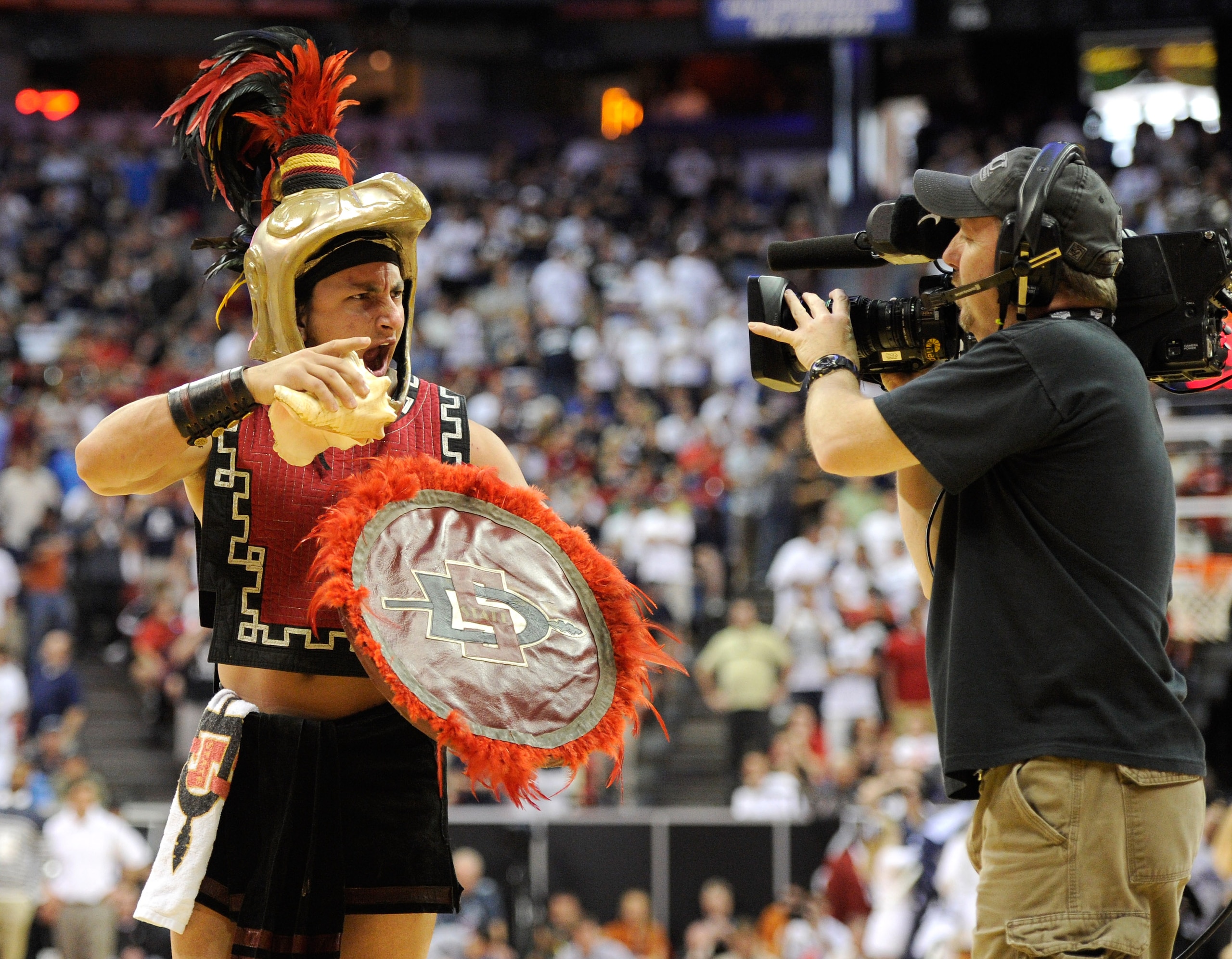 LAS VEGAS, NV - MARCH 12: San Diego State Aztecs mascot Aztec Warrior is filmed on the court during the championship game of the Conoco Mountain West Conference Basketball tournament against the Brigham Young University Cougars at the Thomas & Mack Cente LAS VEGAS, NV - MARCH 12: San Diego State Aztecs mascot Aztec Warrior is filmed on the court during the championship game of the Conoco Mountain West Conference Basketball tournament against the Brigham Young University Cougars at the Thomas & Mack Cente