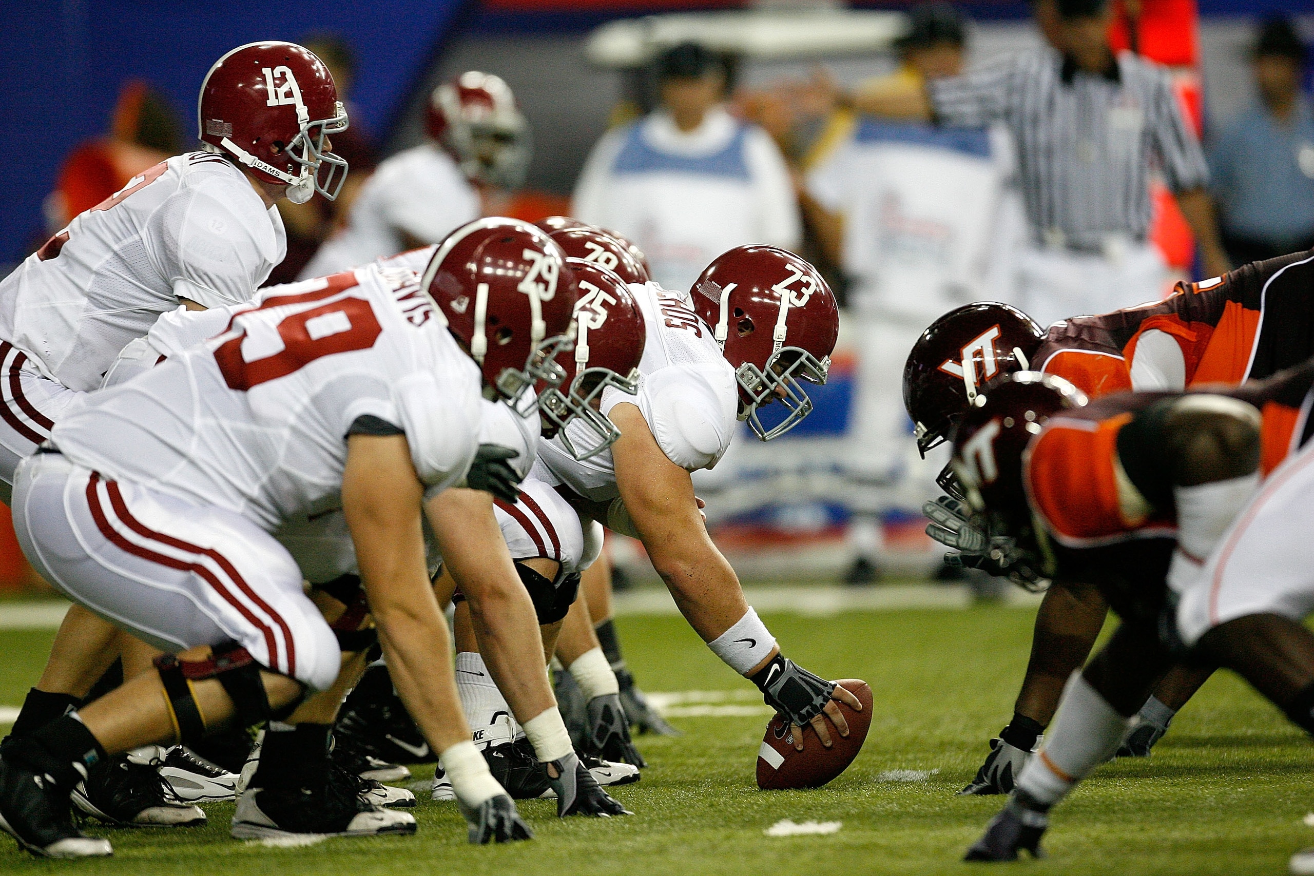 ATLANTA - SEPTEMBER 05:  Quarterback Greg McElroy #12 of the Alabama Crimson Tide takes the snap from William Vlachos #73 against the Virginia Tech Hokies during the Chick-fil-A Kickoff Game at Georgia Dome on September 5, 2009 in Atlanta, Georgia.  (Phot