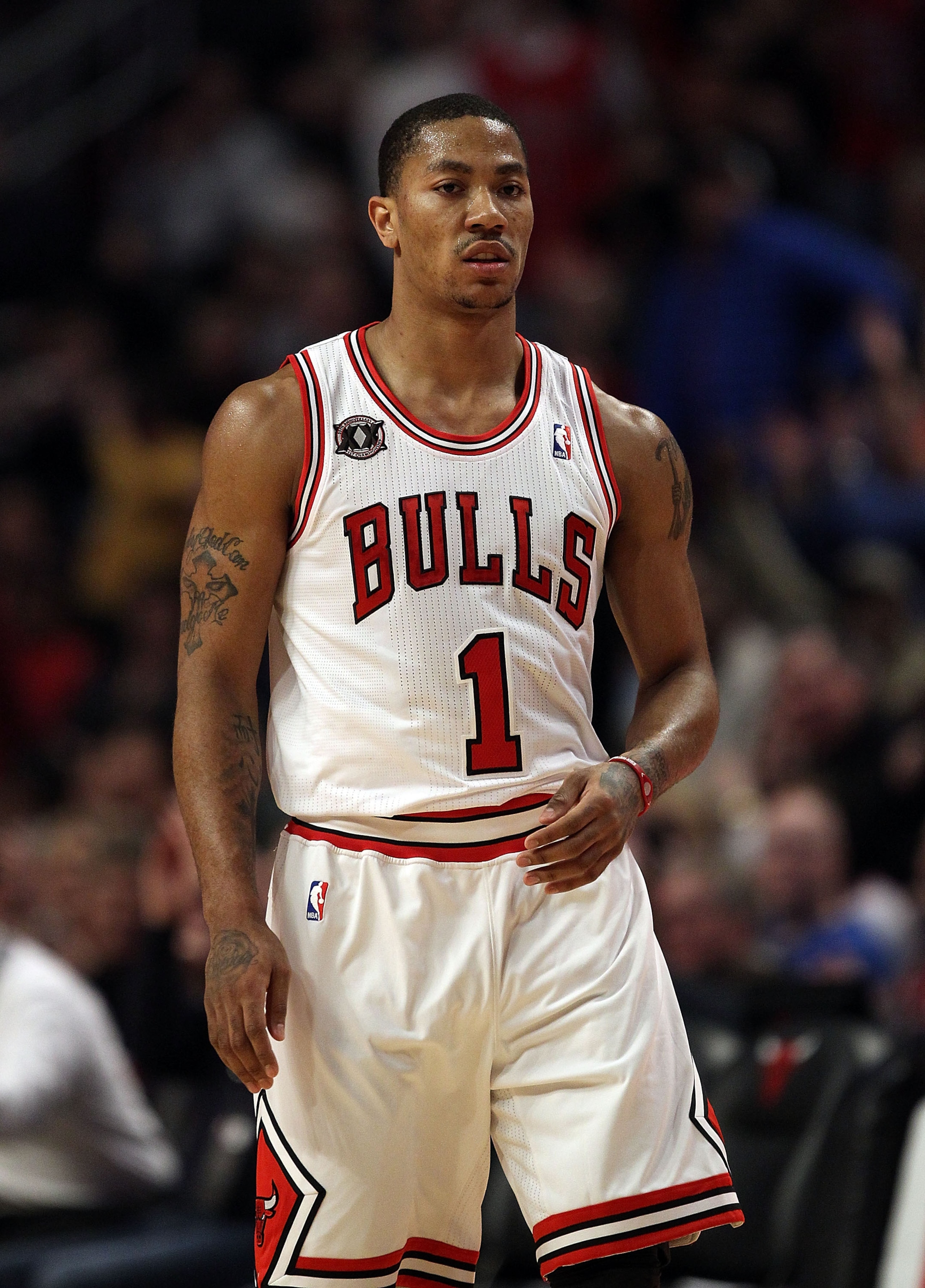 CHICAGO, IL - MARCH 12: Derrick Rose #1 of the Chicago Bulls walks back to the bench after hitting a 3 point shot against the Utah Jazz at the United Center on March 12, 2011 in Chicago, Illinois. The Bulls defeated the Jazz 118-100. NOTE TO USER: User ex