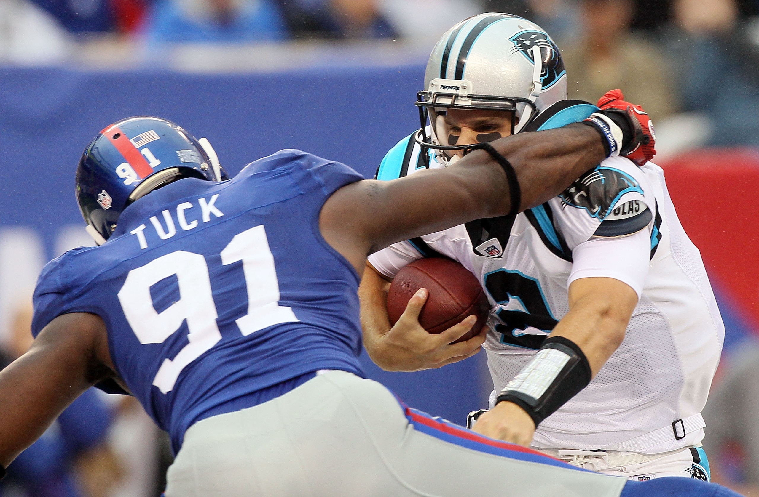 EAST RUTHERFORD, NJ - SEPTEMBER 12: Jimmy Clausen #2 of the Carolina Panthers tries to avoid a sack attempt from Justin Tuck #91 of the New York Giants on September 12, 2010 at the New Meadowlands Stadium in East Rutherford, New Jersey. The Giants defeat EAST RUTHERFORD, NJ - SEPTEMBER 12: Jimmy Clausen #2 of the Carolina Panthers tries to avoid a sack attempt from Justin Tuck #91 of the New York Giants on September 12, 2010 at the New Meadowlands Stadium in East Rutherford, New Jersey. The Giants defeat