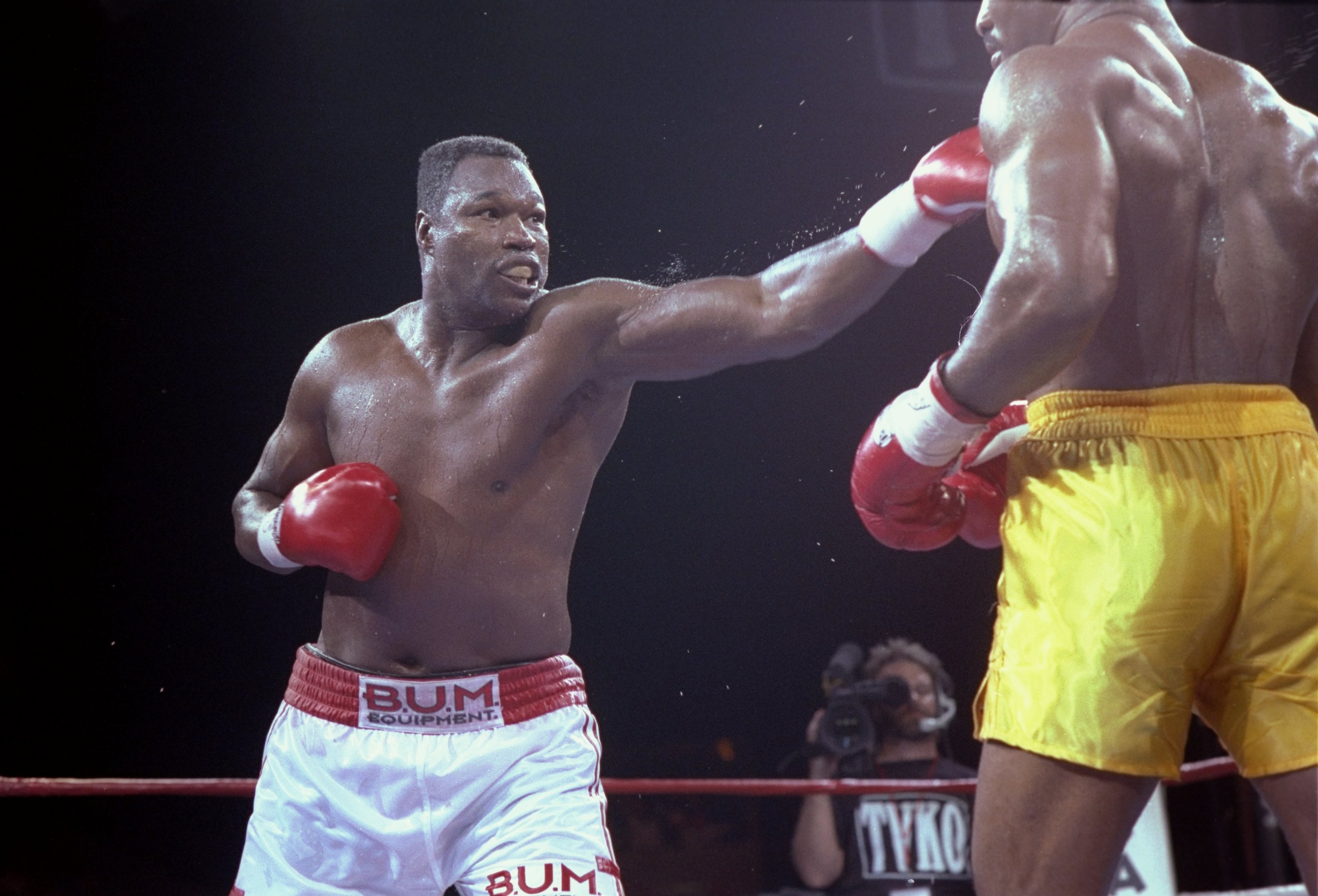 19 Jun 1992: Larry Holmes (left) lands a blow to the face of his opponent Evander Holyfield in Las Vegas, Nevada. Holyfield won the bout with an unanimous decision after 12 rounds.