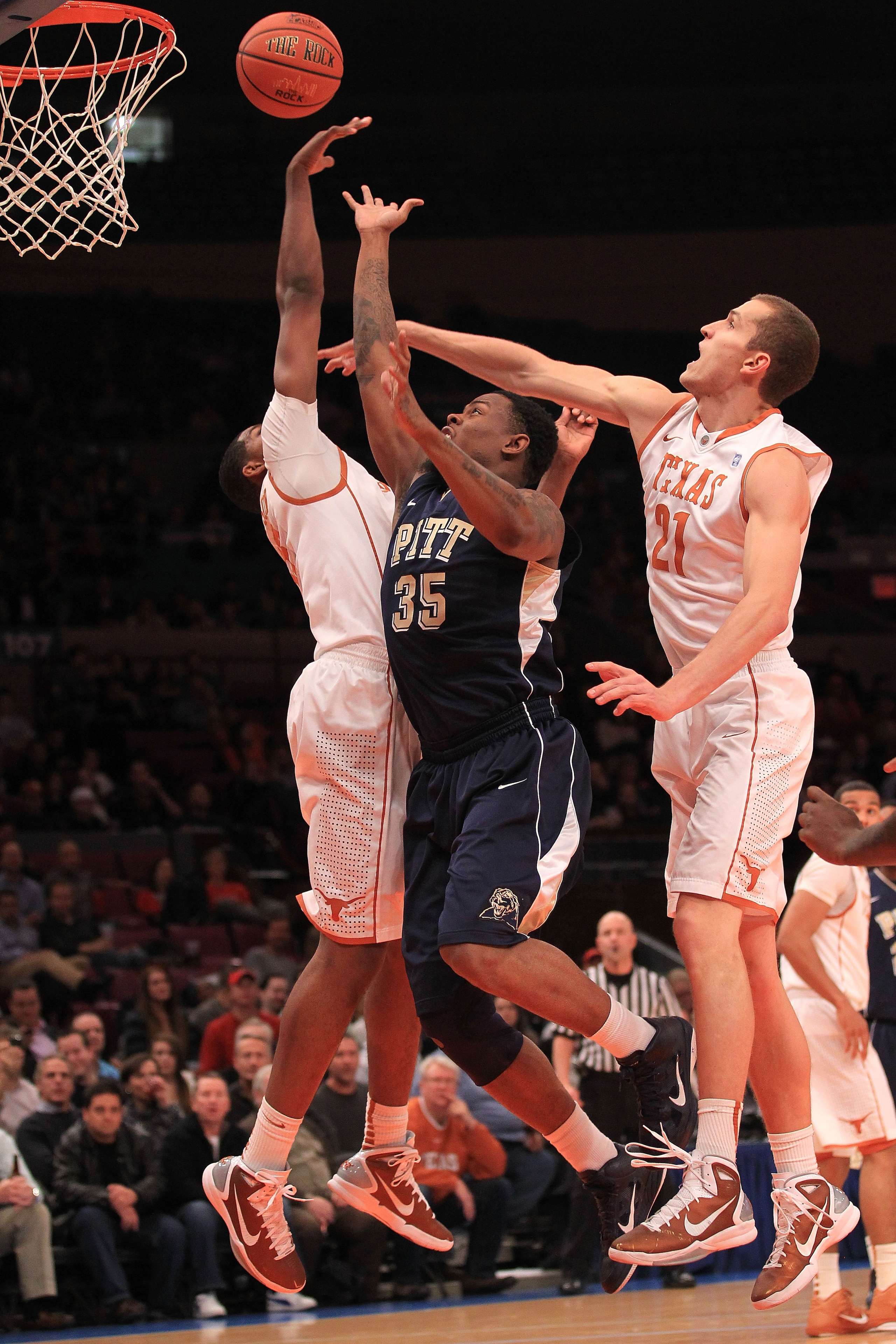 NEW YORK - NOVEMBER 19:  Nasir Robinson #35 of the Pittsburgh Panthers shoots between Tristan Thompson #13 and Matt Hill #21 of the Texas Longhorns during the Championship game of the 2k Sports Classic at Madison Square Garden on November 19, 2010 in New