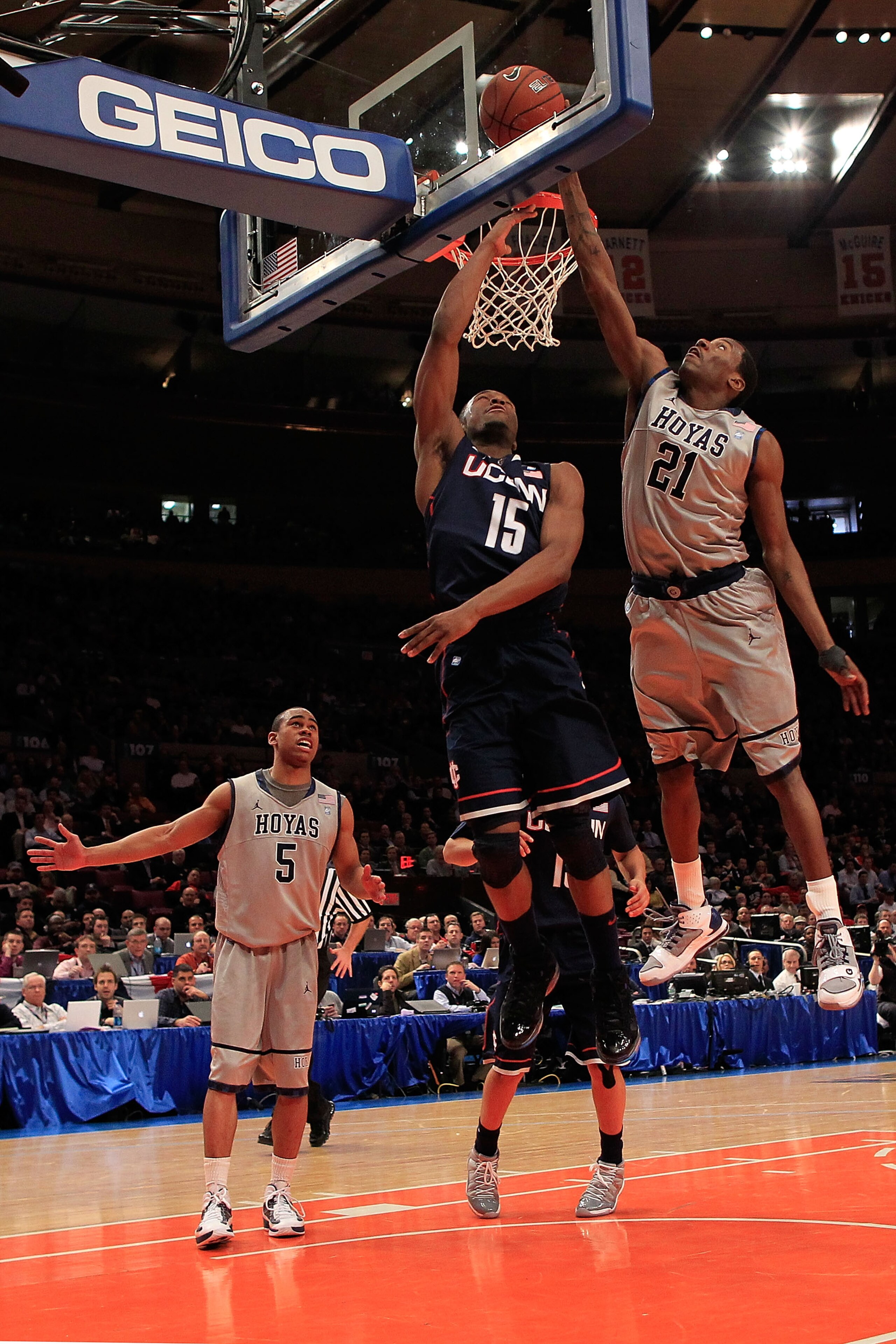 NEW YORK, NY - MARCH 09:  Kemba Walker #15 of the Connecticut Huskies lays the ball up against Jason Clark #21 of the Georgetown Hoyas during the second round of the 2011 Big East Men's Basketball Tournament presented by American Eagle Outfitters at Madis