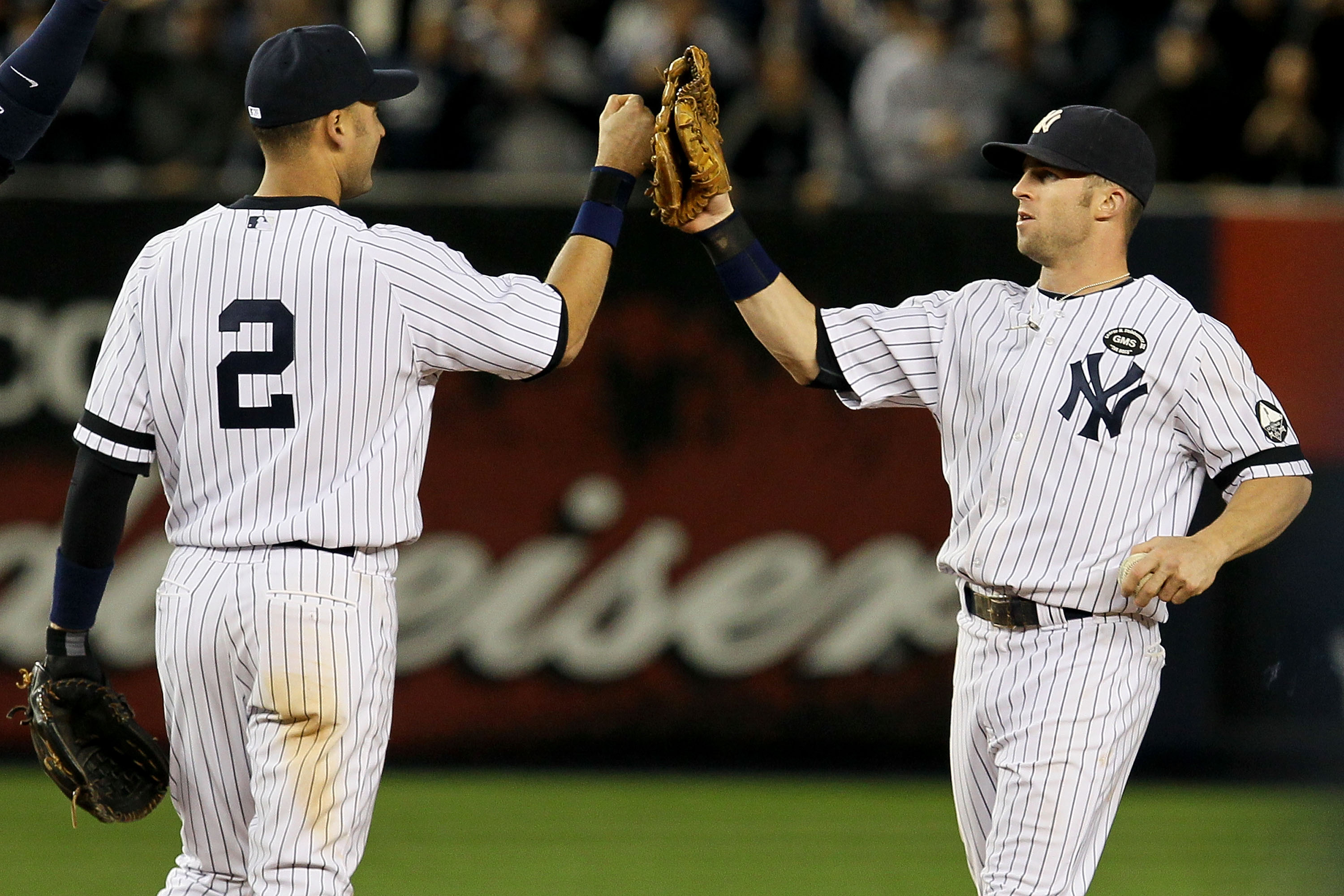 NEW YORK - OCTOBER 09:  (L-R) Derek Jeter #2 and Brett Gardner #11 of the New York Yankees celebrate after their 6-1 win against the Minnesota Twins during Game Three of the ALDS part of the 2010 MLB Playoffs at Yankee Stadium on October 9, 2010 in the Br