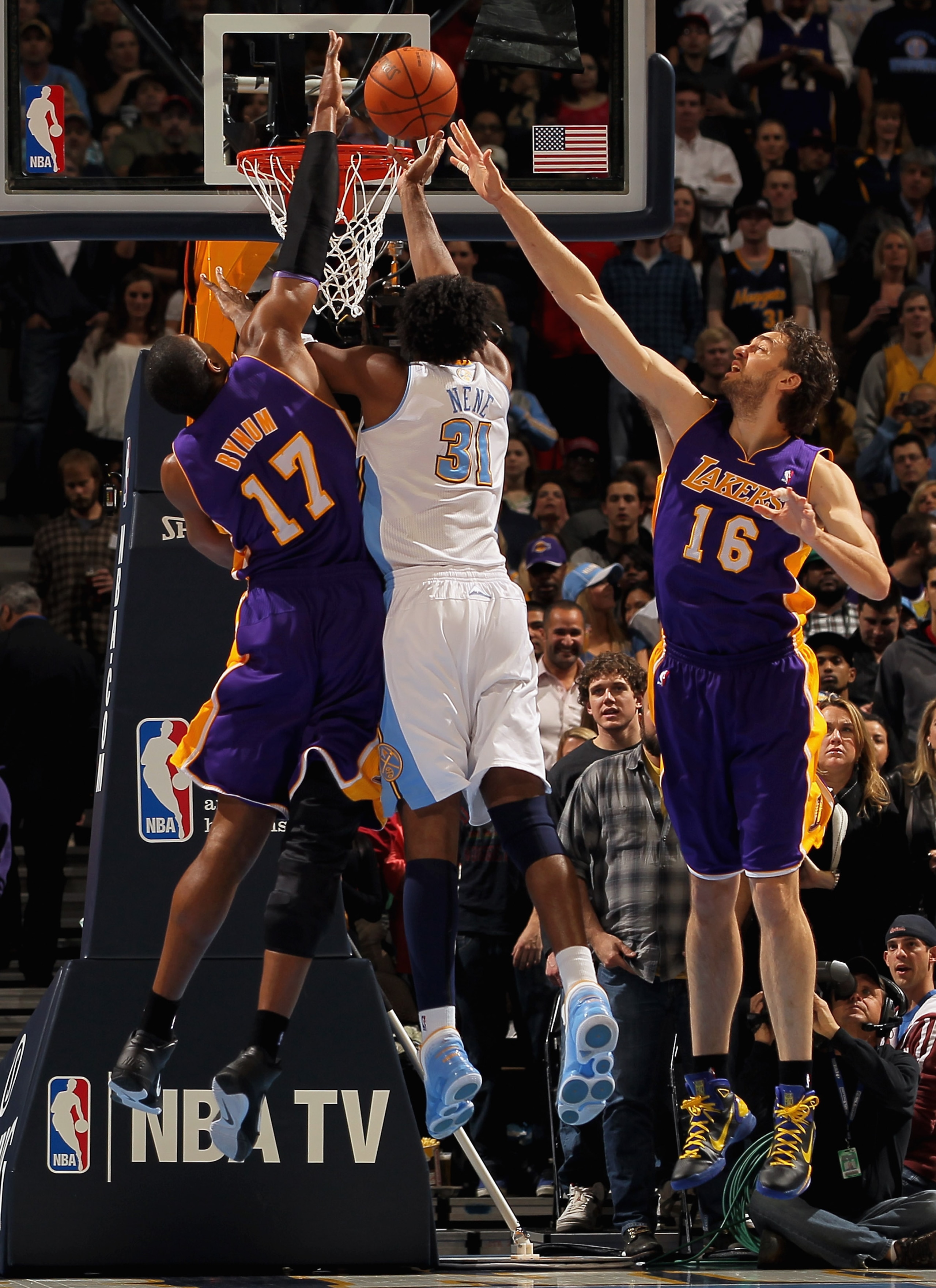DENVER, CO - JANUARY 21:  Nene #31 of the Denver Nuggets puts up a shot between Andrew Bynum #17 and Pau Gasol #16 of the Los Angeles Lakers at the Pepsi Center on January 21, 2011 in Denver, Colorado. NOTE TO USER: User expressly acknowledges and agrees