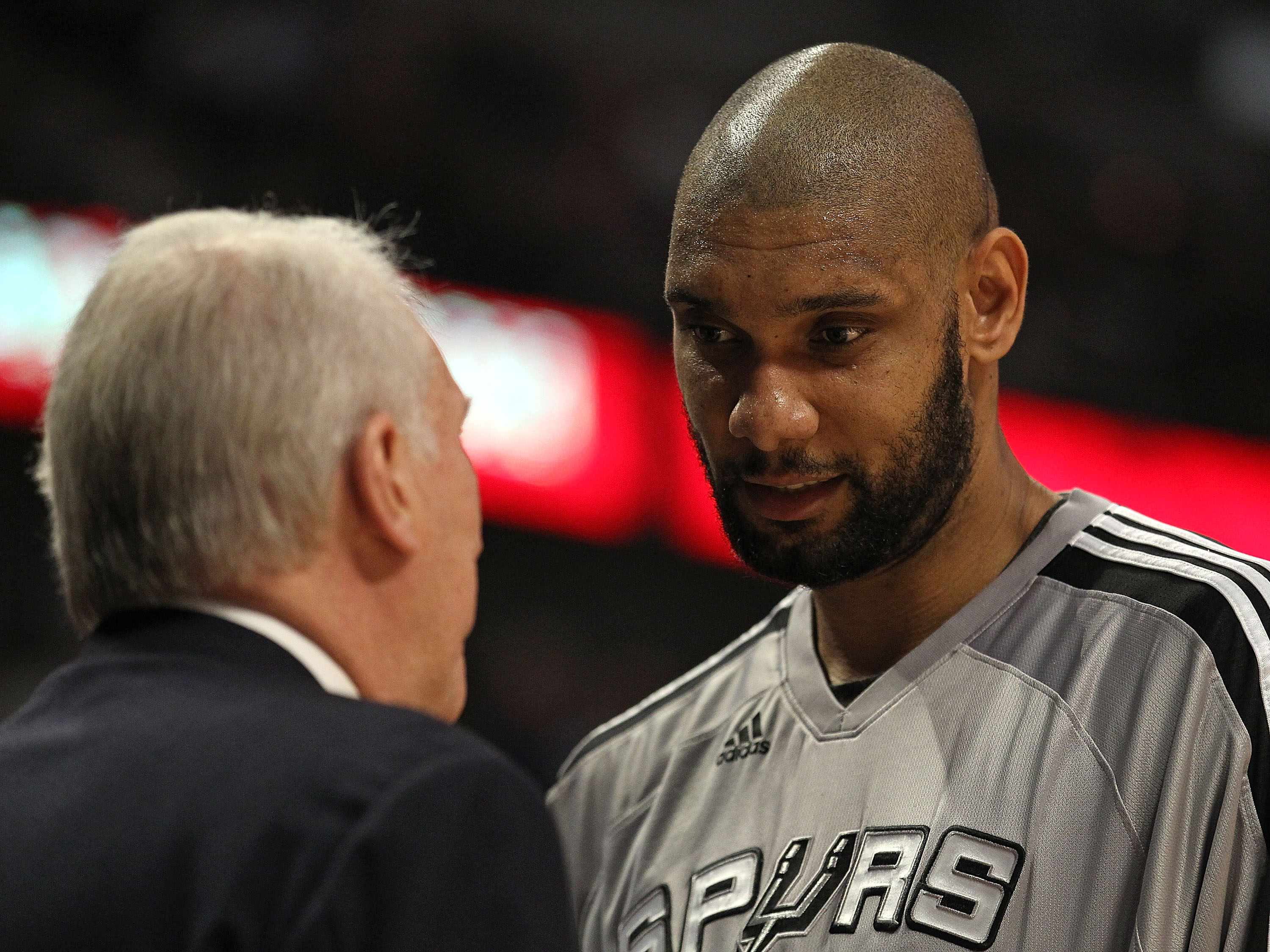 CHICAGO, IL - FEBRUARY 17: Tim Duncan #21 of the San Antonio Spurs talks with head coach Gregg Popovich during a game against the Chicago Bulls at the United Center on February 17, 2011 in Chicago, Illinois. The Bulls defeated the Spurs 109-99. NOTE TO US